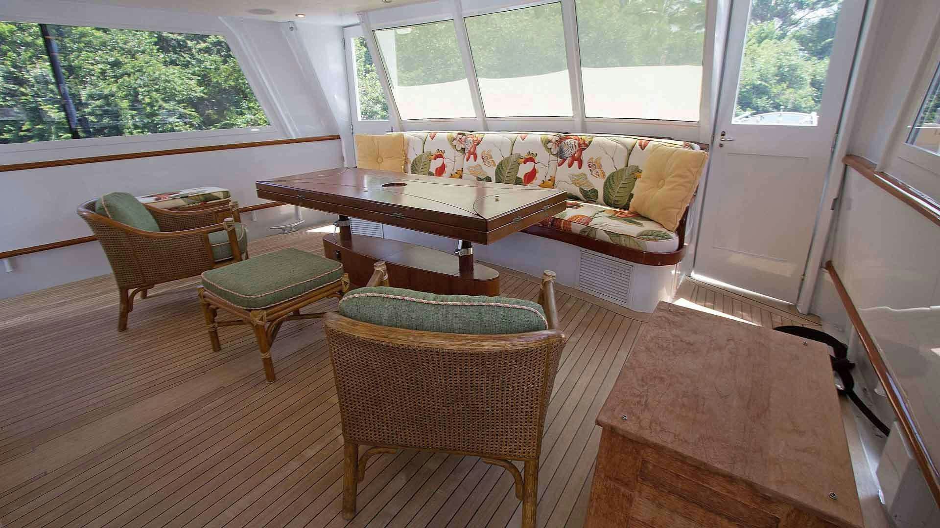a living room with a couch and chairs aboard KOALA Yacht for Charter