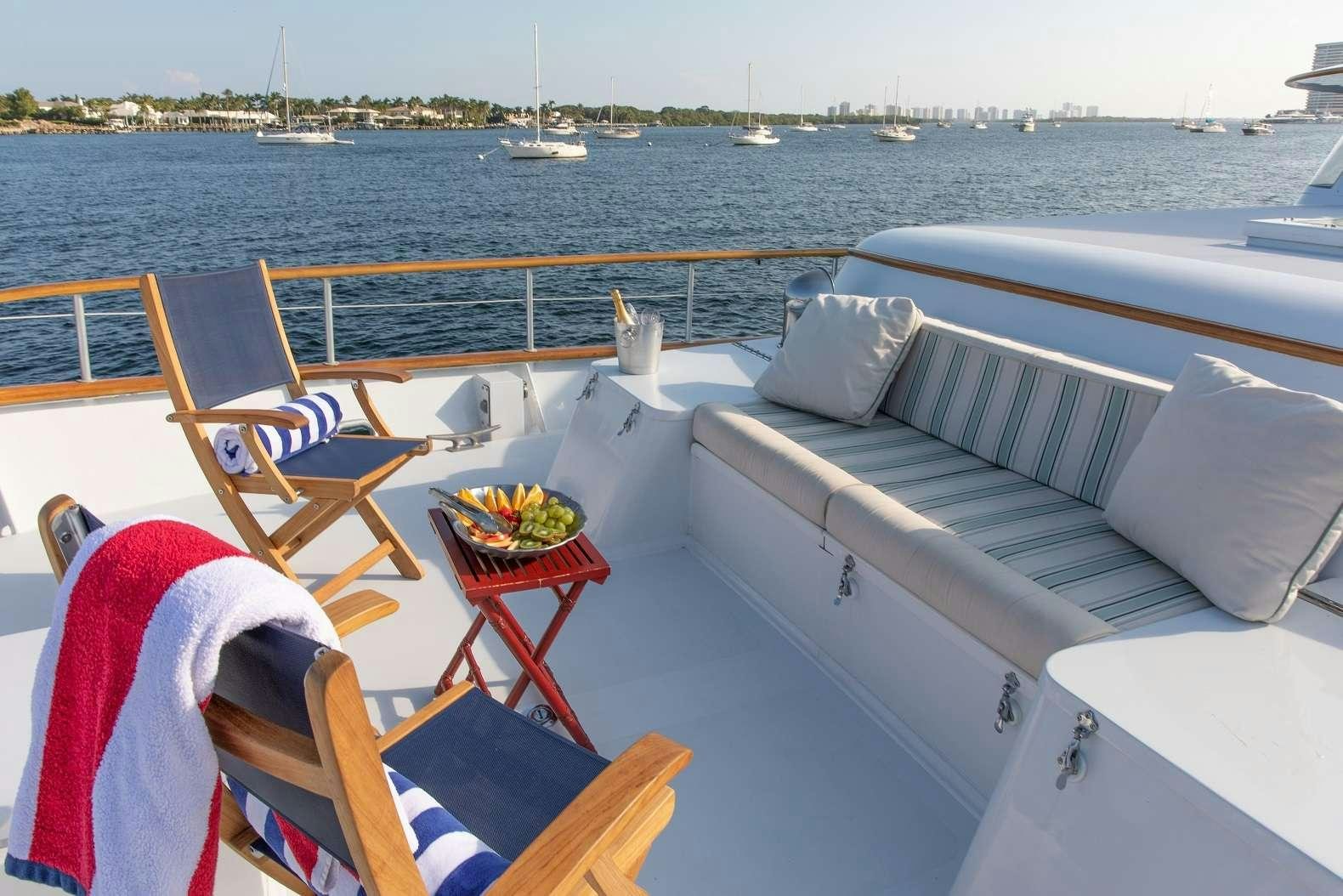 a boat with a table and chairs on it aboard KOALA Yacht for Charter