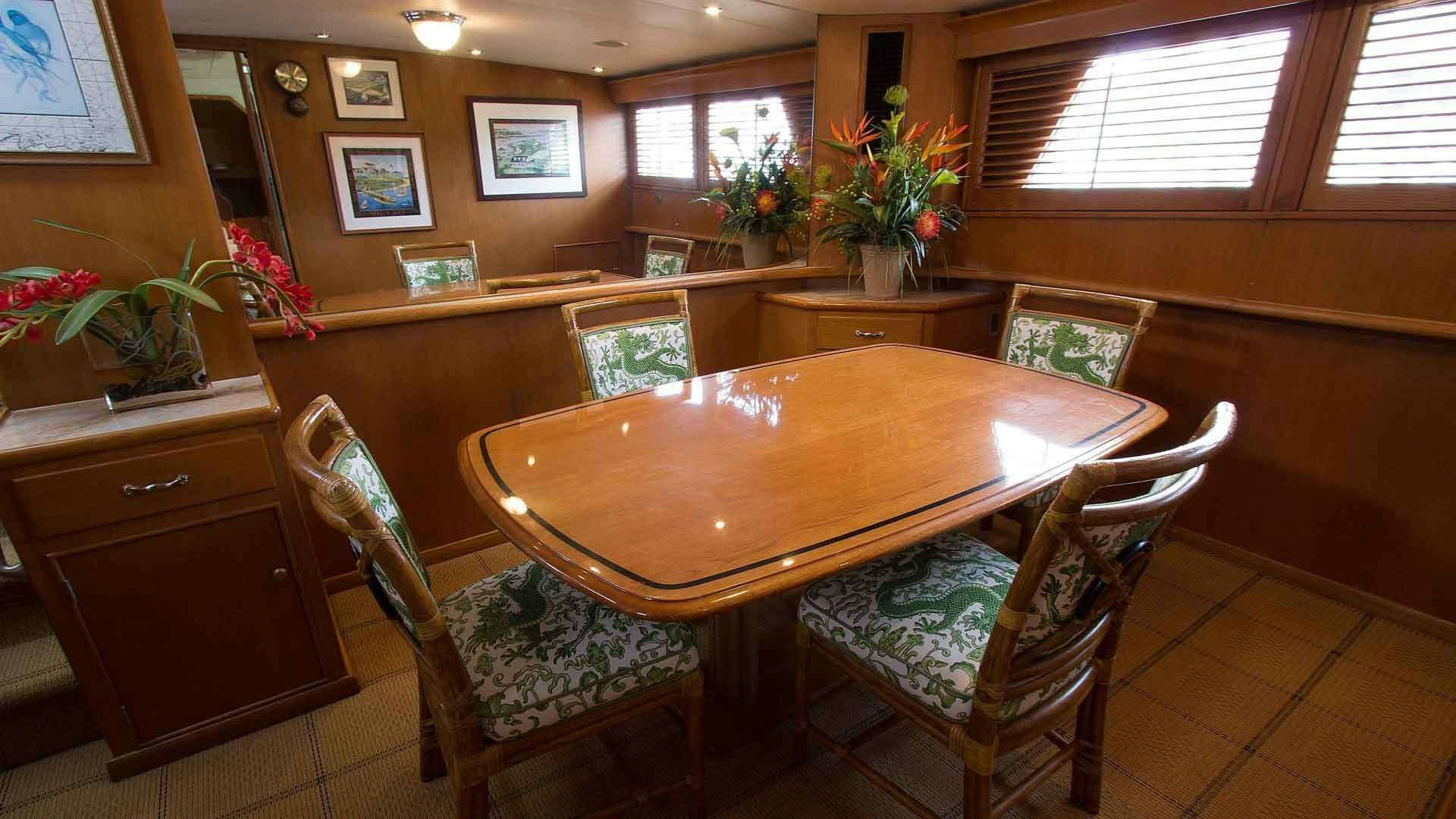 a dining table in a room aboard KOALA Yacht for Charter