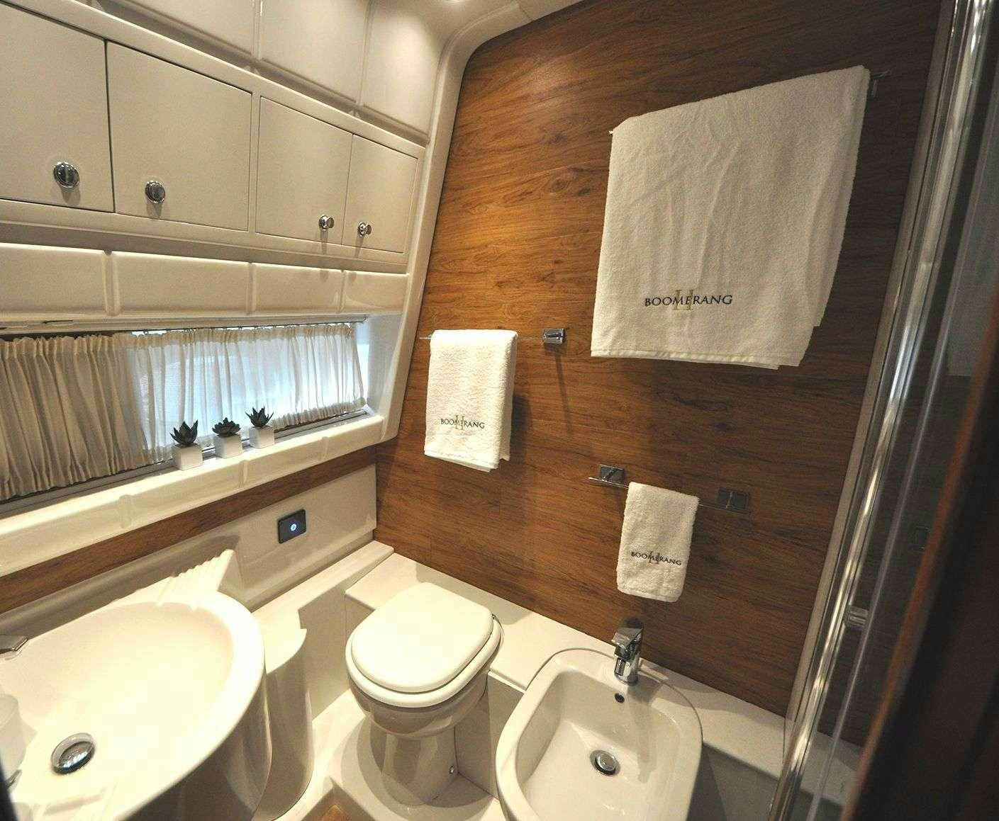 a bathroom with a toilet sink and a mirror aboard Boomerang II Yacht for Charter