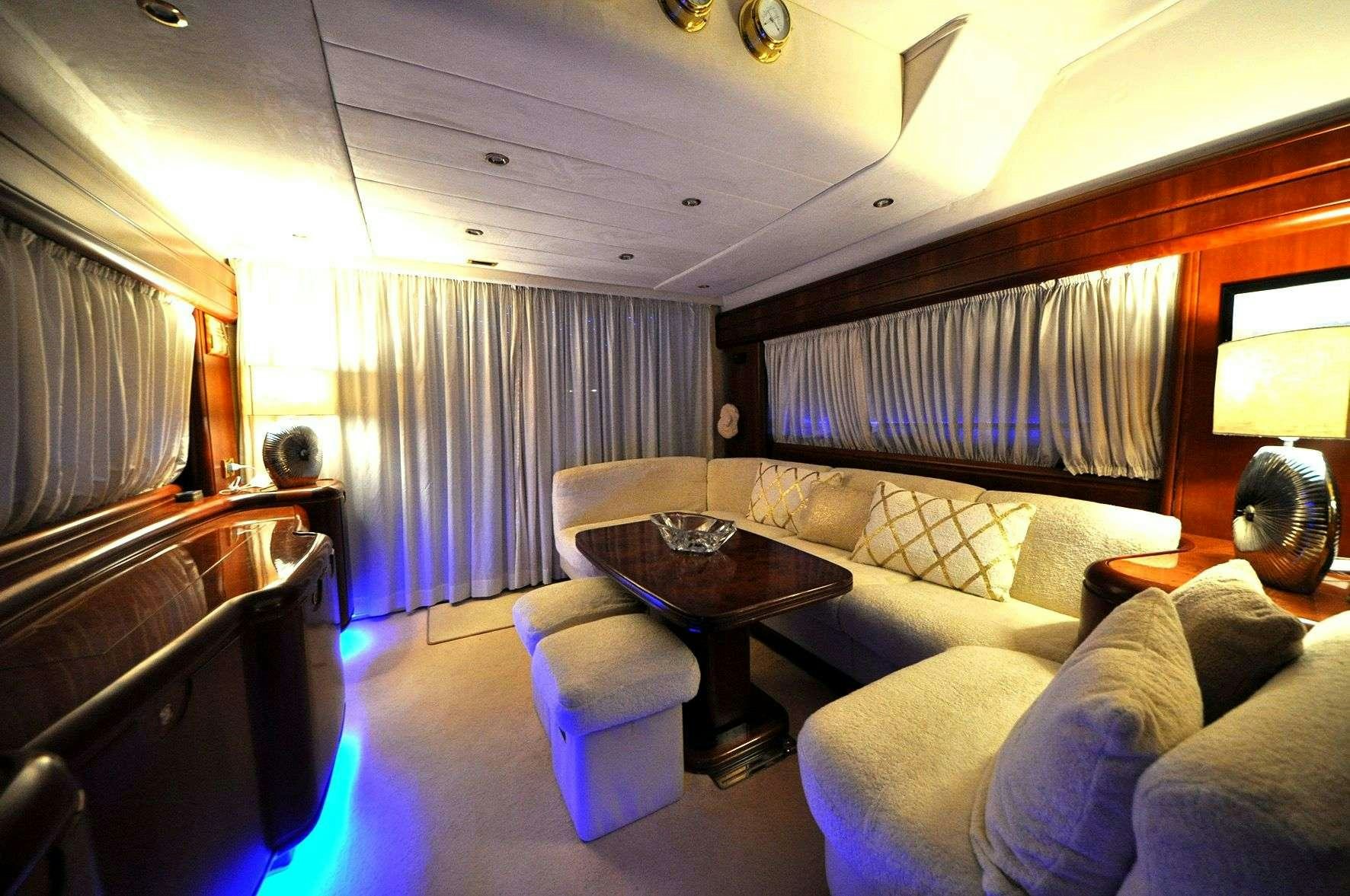 a living room with a couch and a coffee table aboard Boomerang II Yacht for Charter