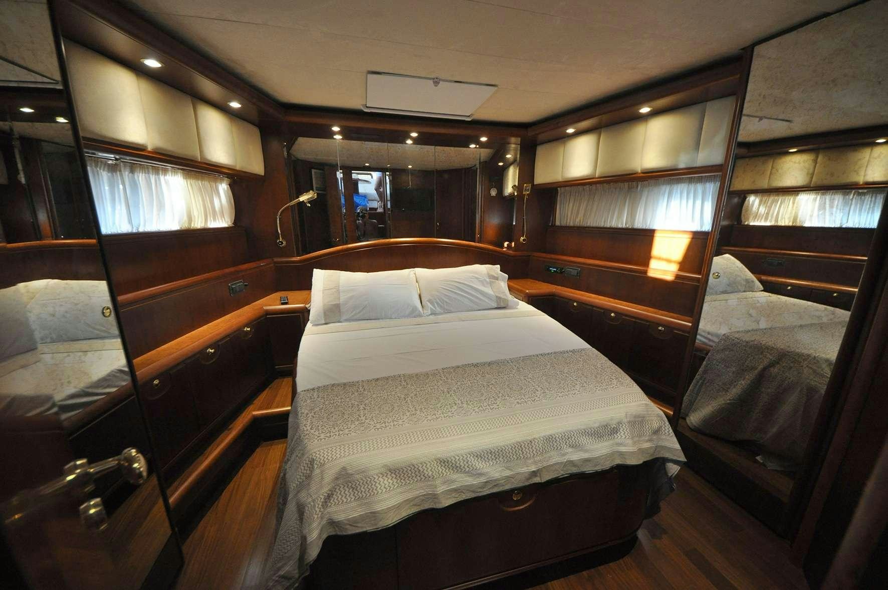 a room with a bed and a chair aboard Boomerang II Yacht for Charter