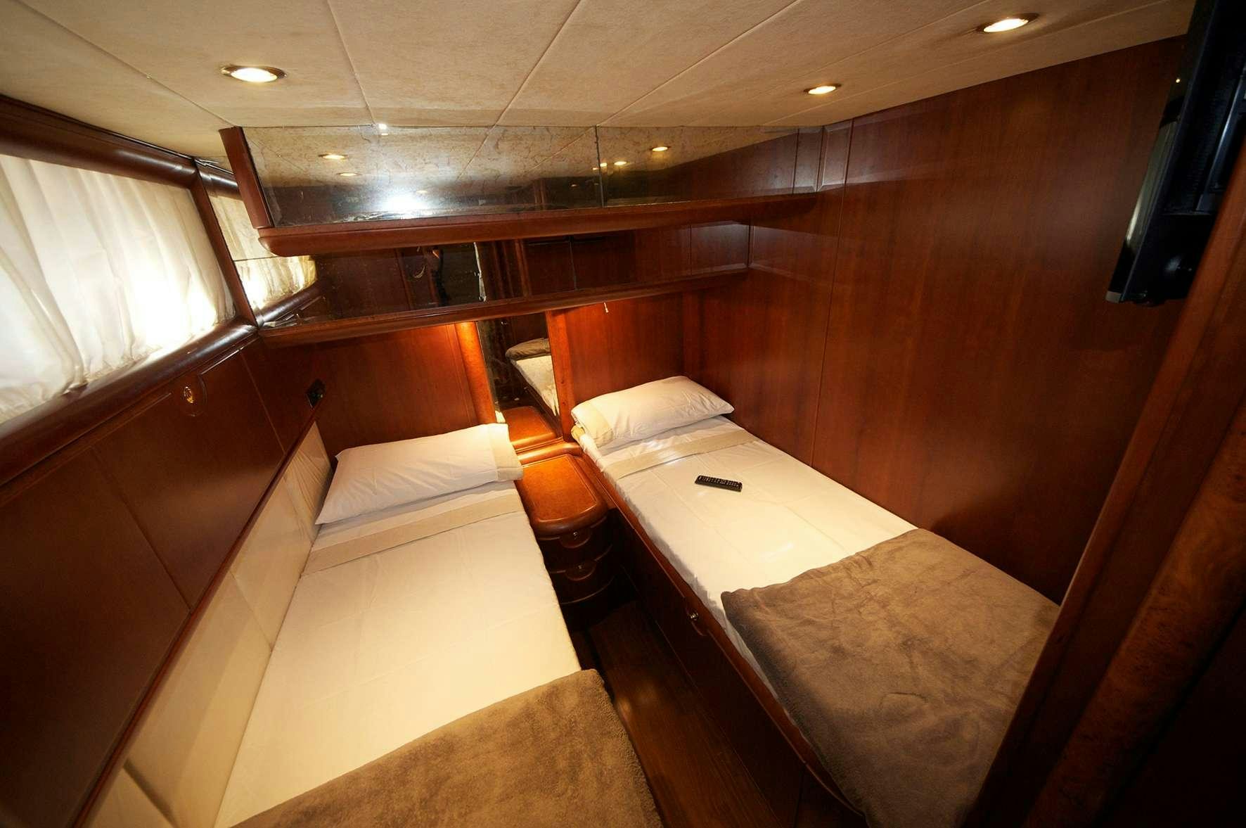 a room with beds and a window aboard Boomerang II Yacht for Charter