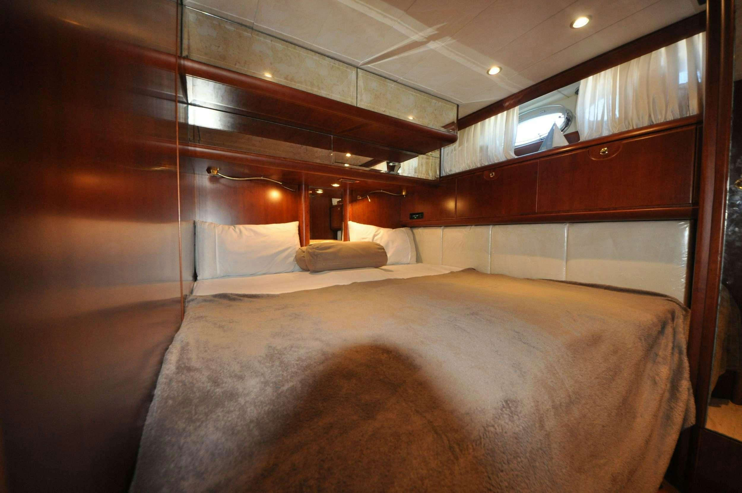 a bed with a white bed aboard Boomerang II Yacht for Charter