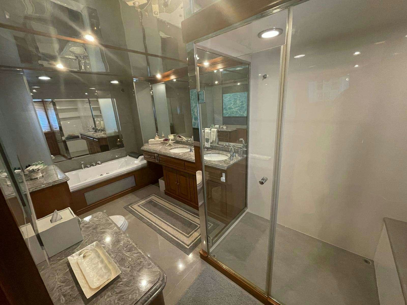 a bathroom with a glass shower aboard SCOTT FREE Yacht for Charter