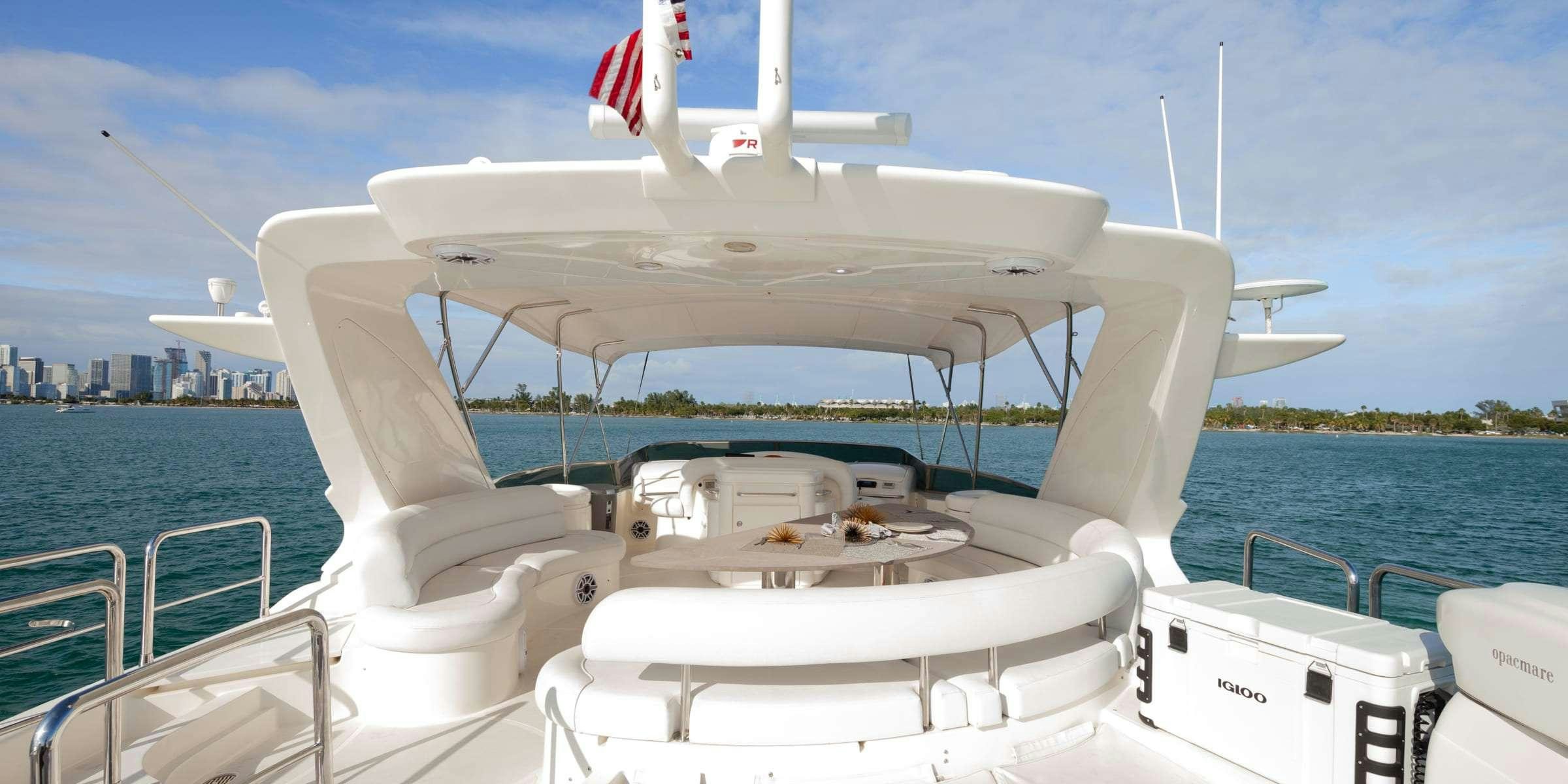 a boat with a flag on the front aboard TRUCO II Yacht for Charter