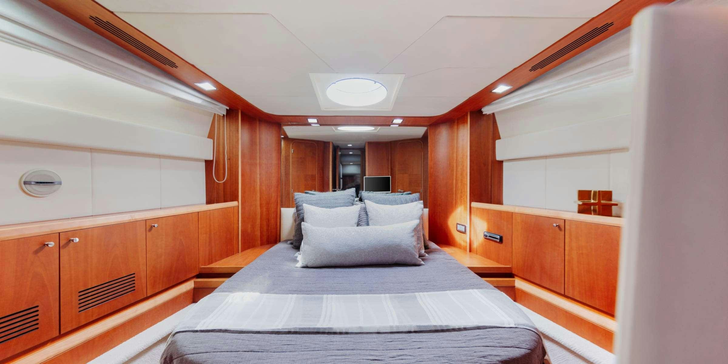 a bed in a room aboard TRUCO II Yacht for Charter