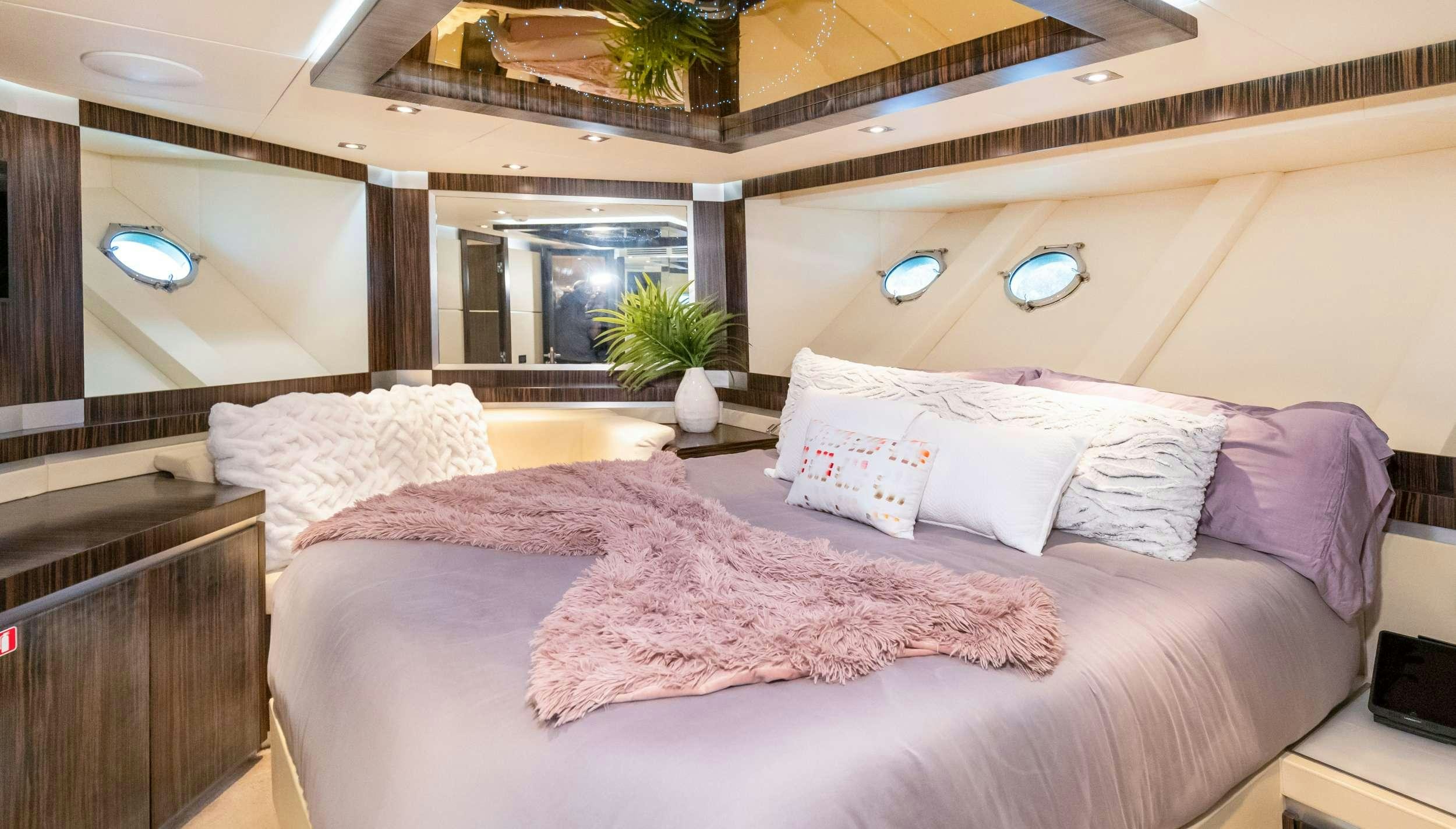 a room with a bed and a desk aboard CASUAL Yacht for Charter