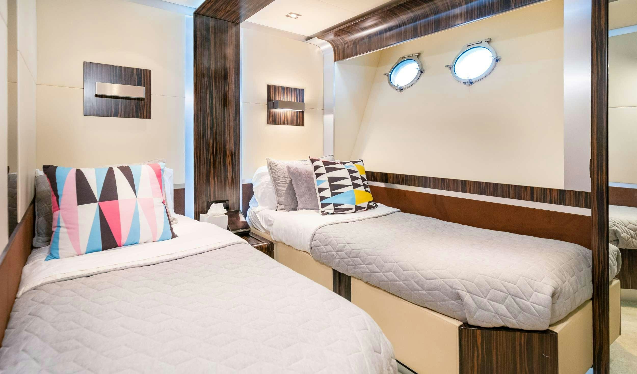 a couple of beds in a hotel room aboard CASUAL Yacht for Charter