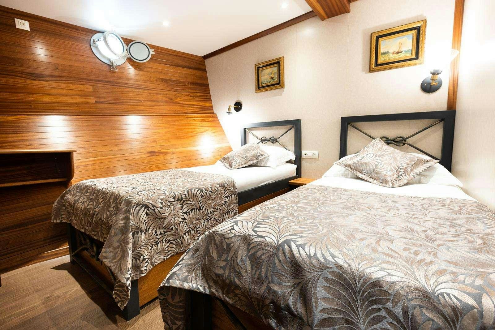a couple of beds in a room aboard GALLANT Yacht for Charter