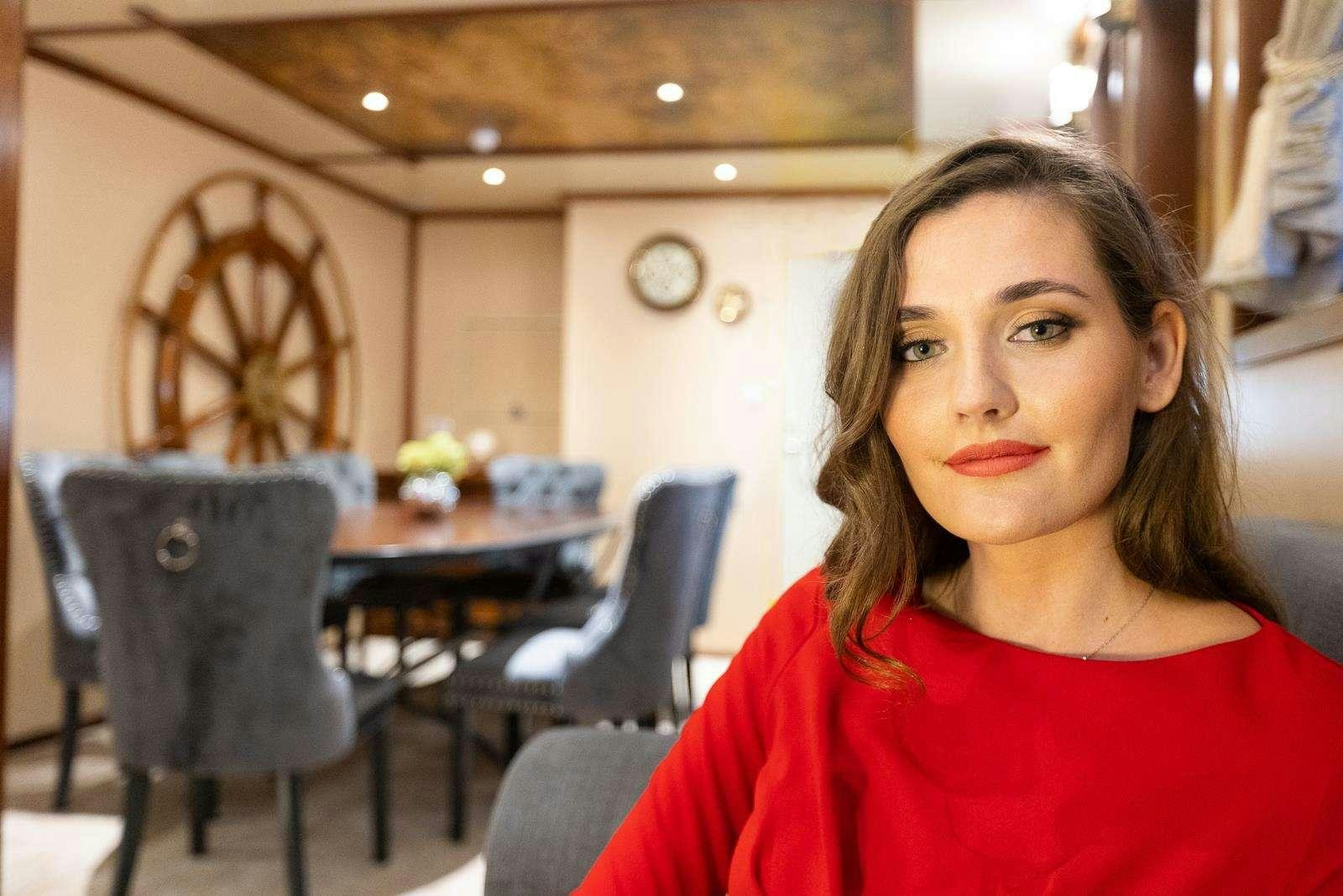 a person sitting in a room aboard GALLANT Yacht for Charter