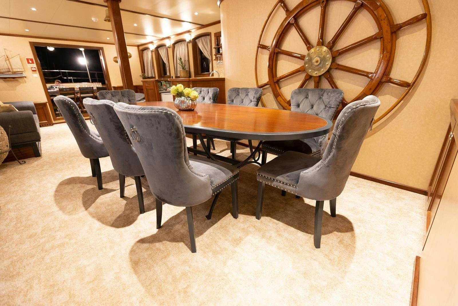 a room with a table and chairs aboard GALLANT Yacht for Charter