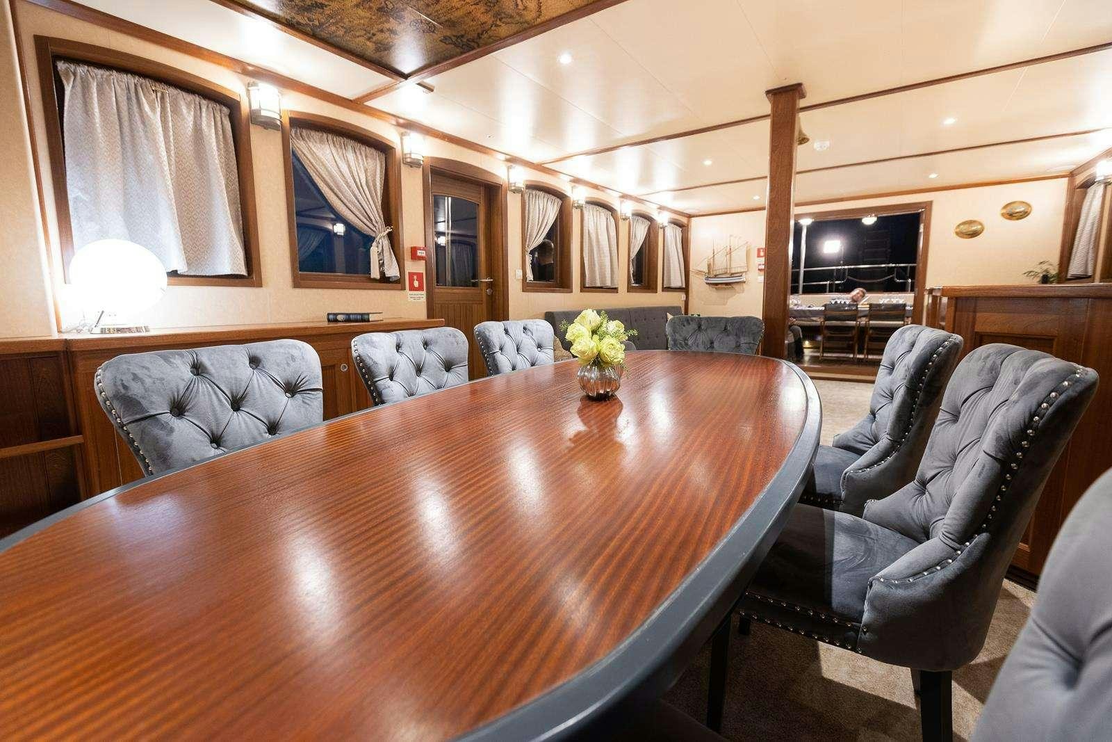 a living room with a wood table aboard GALLANT Yacht for Charter