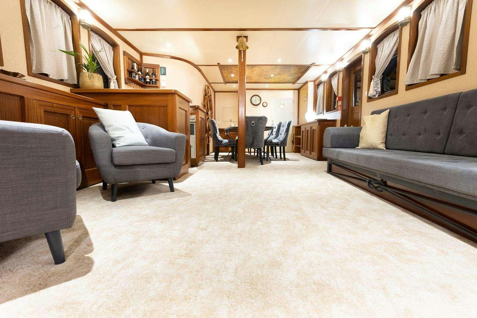 a living room with a couch and a table aboard GALLANT Yacht for Charter