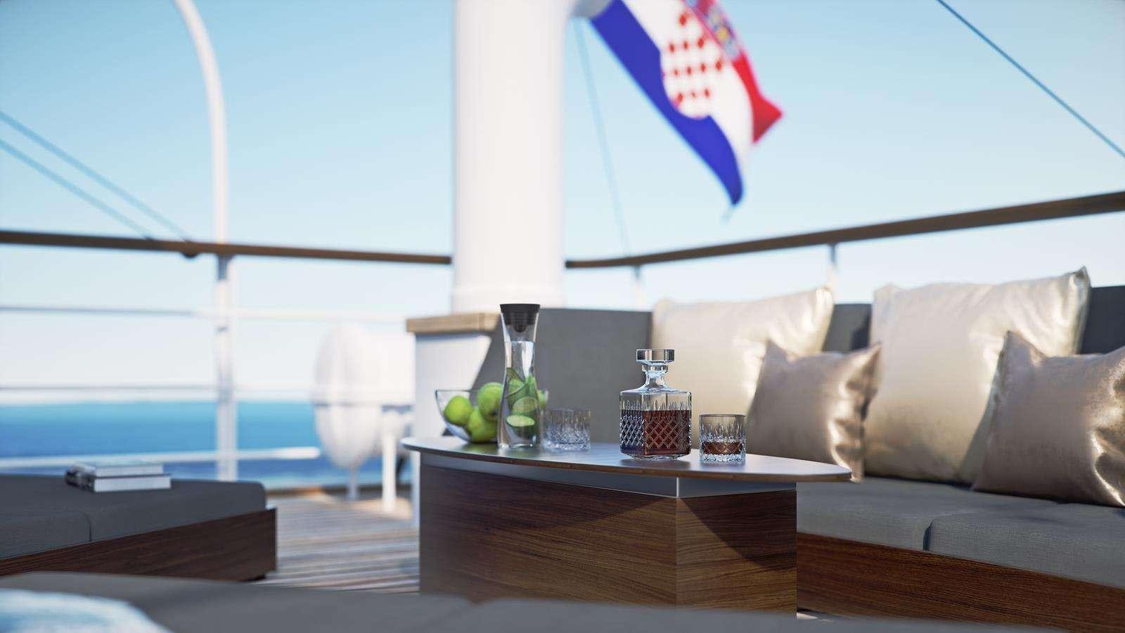a living room with a couch and a table with a flag aboard GALLANT Yacht for Charter