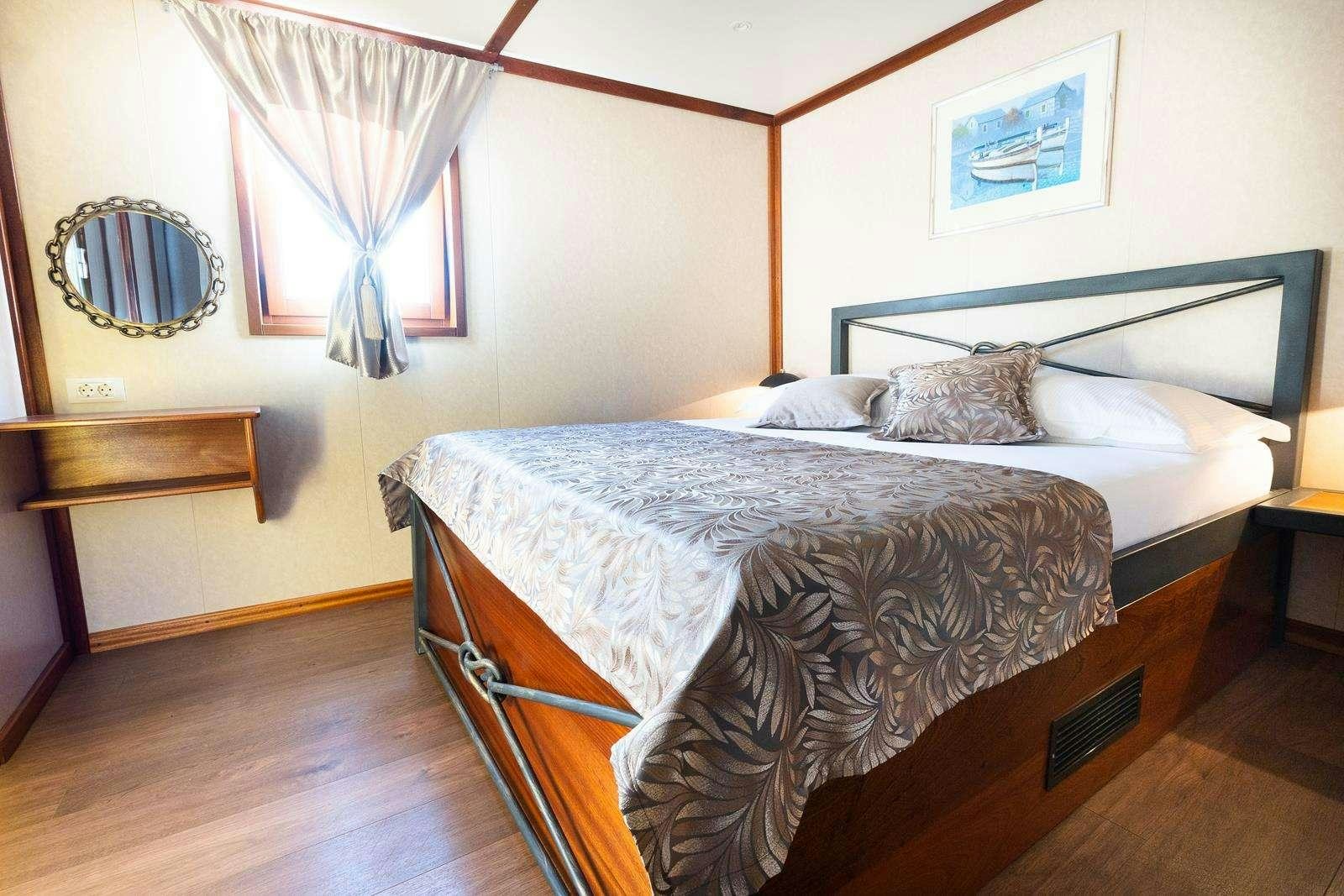 a bed with a canopy over it aboard GALLANT Yacht for Charter