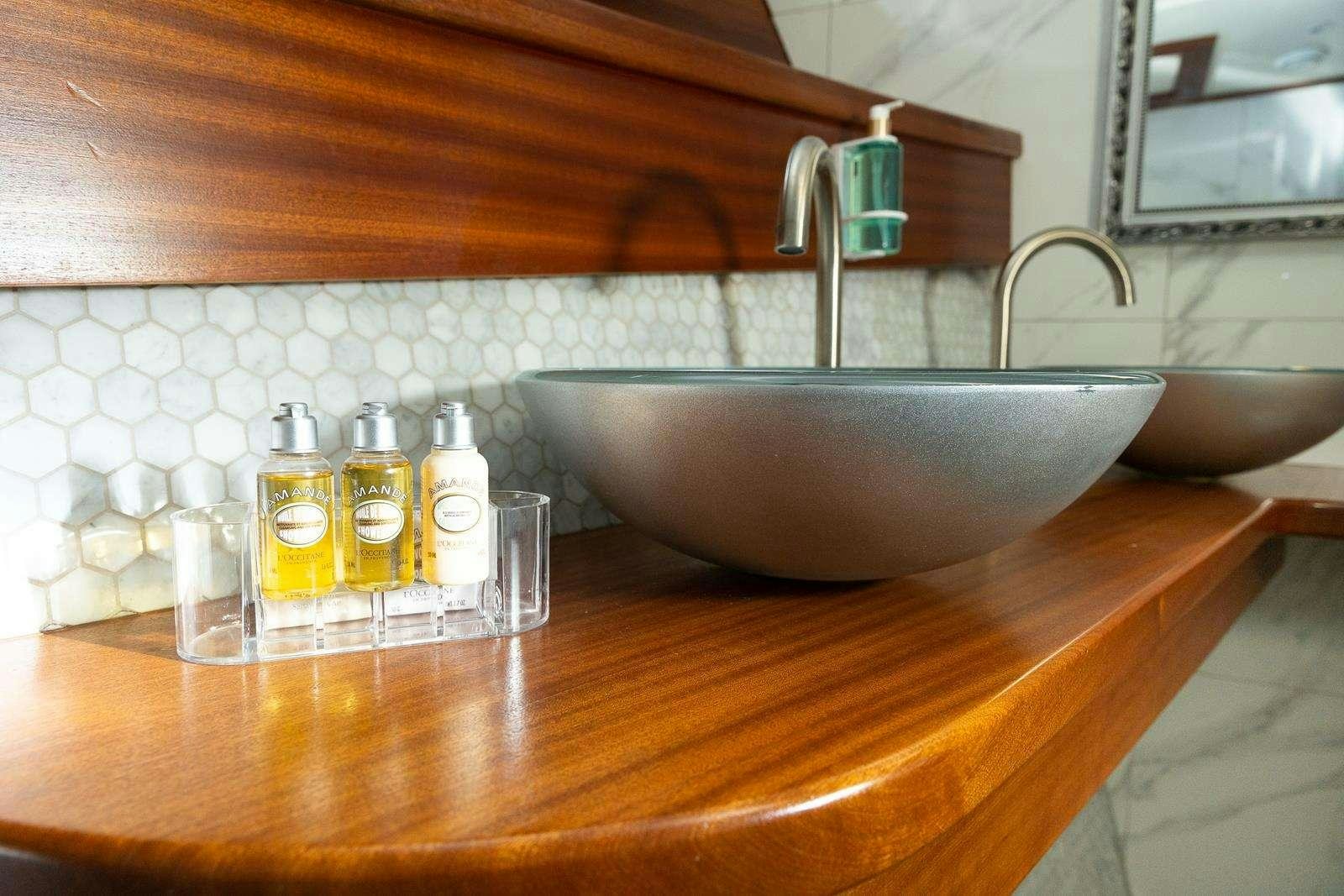 a sink with bottles on it aboard GALLANT Yacht for Charter