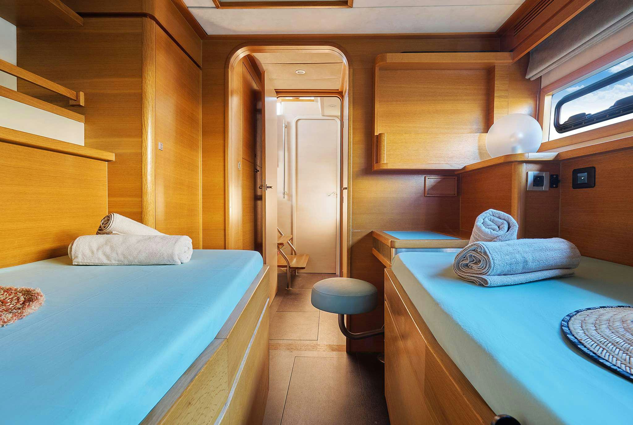 a room with a bed and a door aboard STADIUM Yacht for Charter