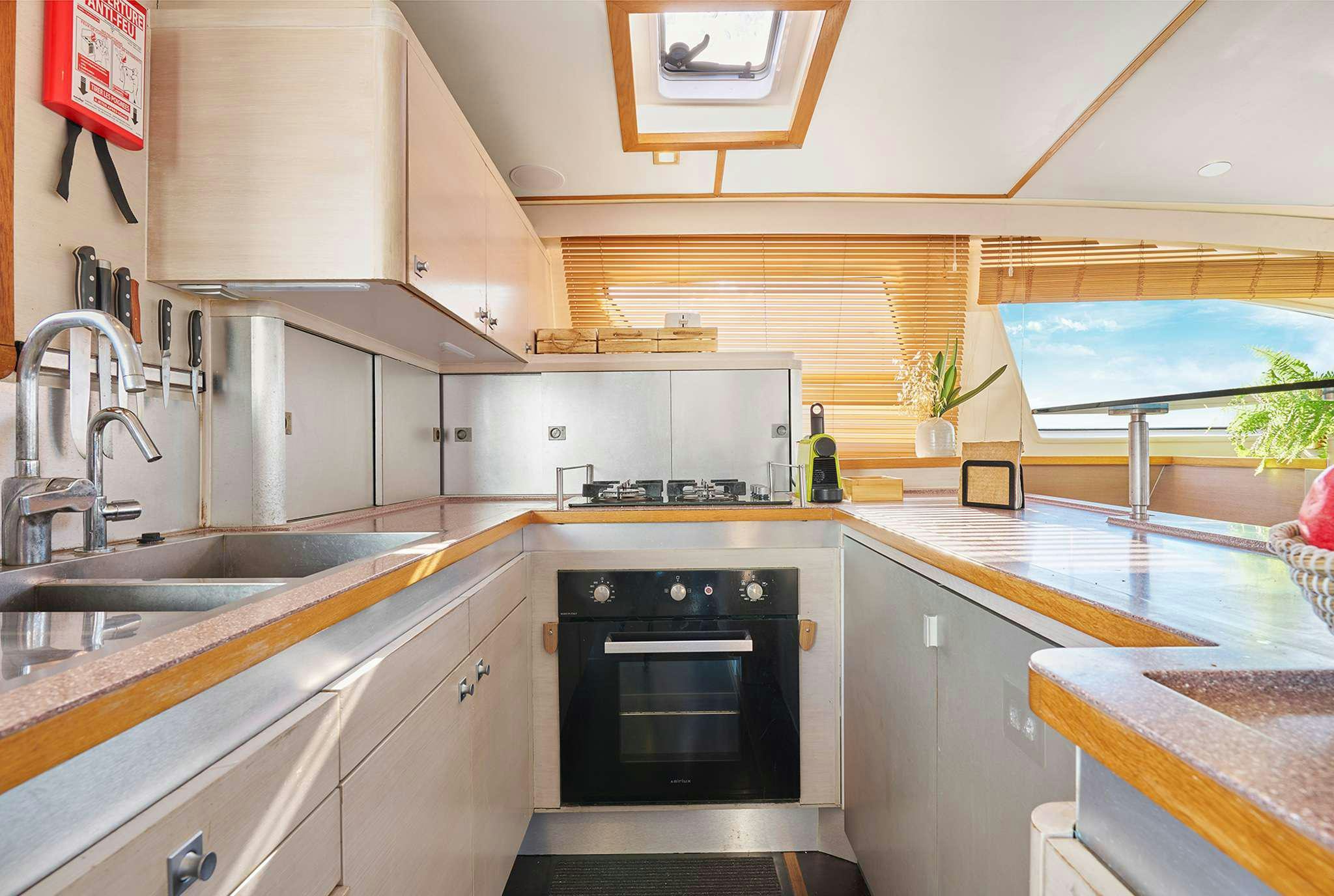 a kitchen with a stove and sink aboard STADIUM Yacht for Charter