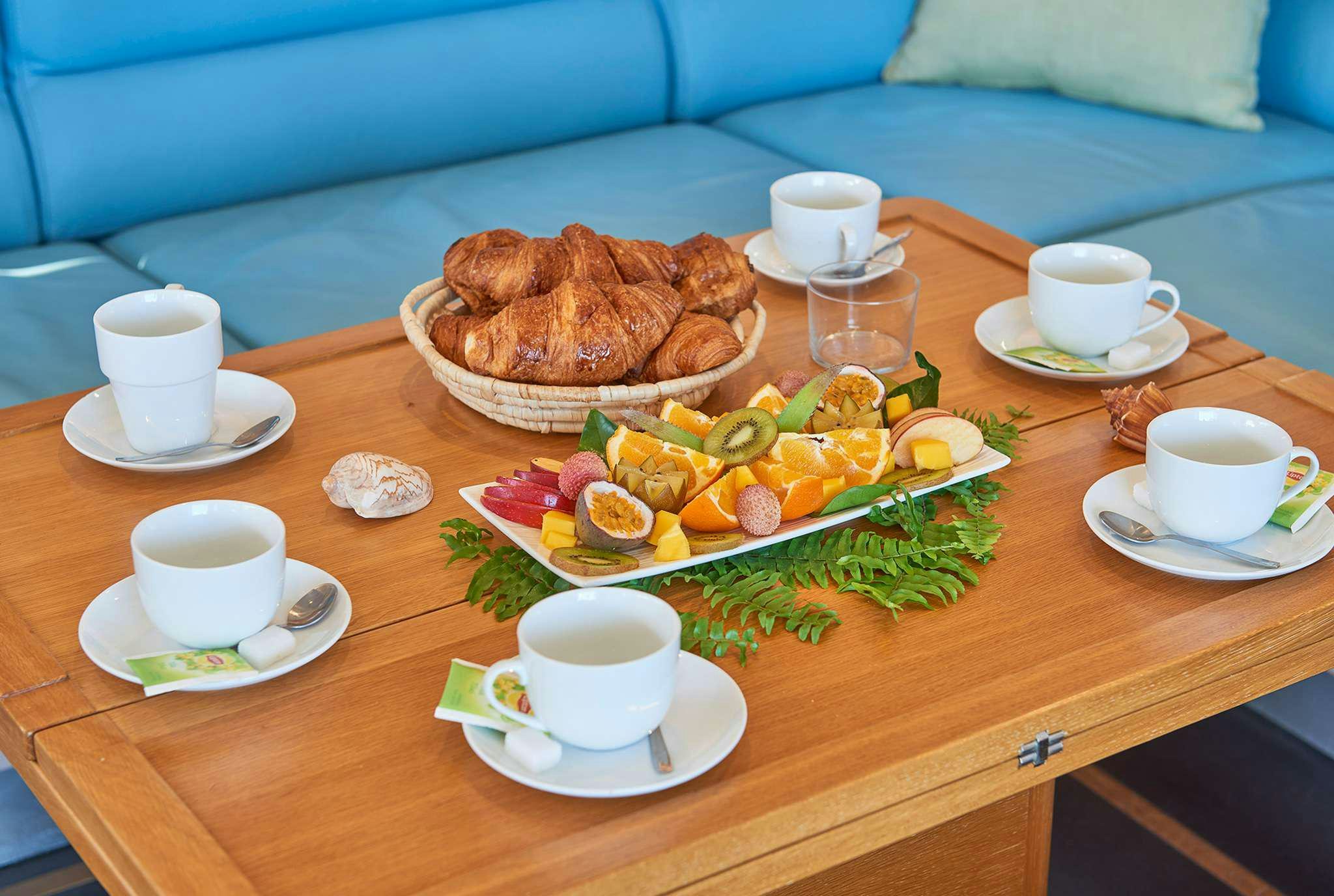 a table with food and cups on it aboard STADIUM Yacht for Charter
