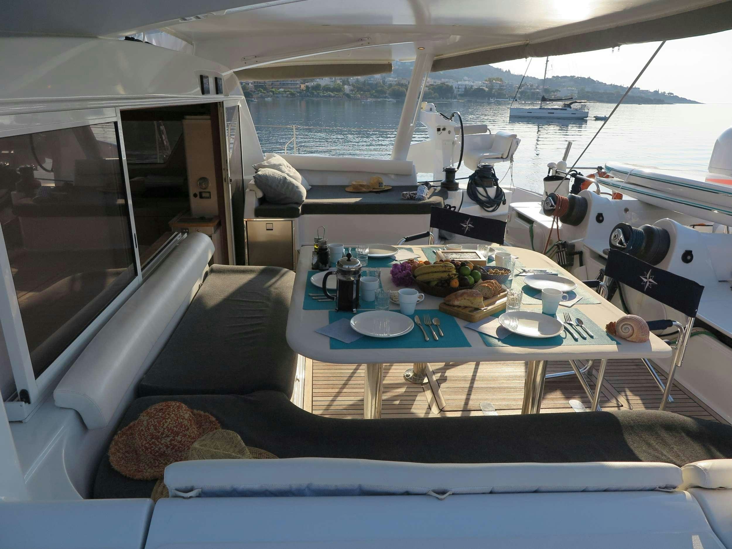 a boat with a table and plates on it aboard STADIUM Yacht for Charter