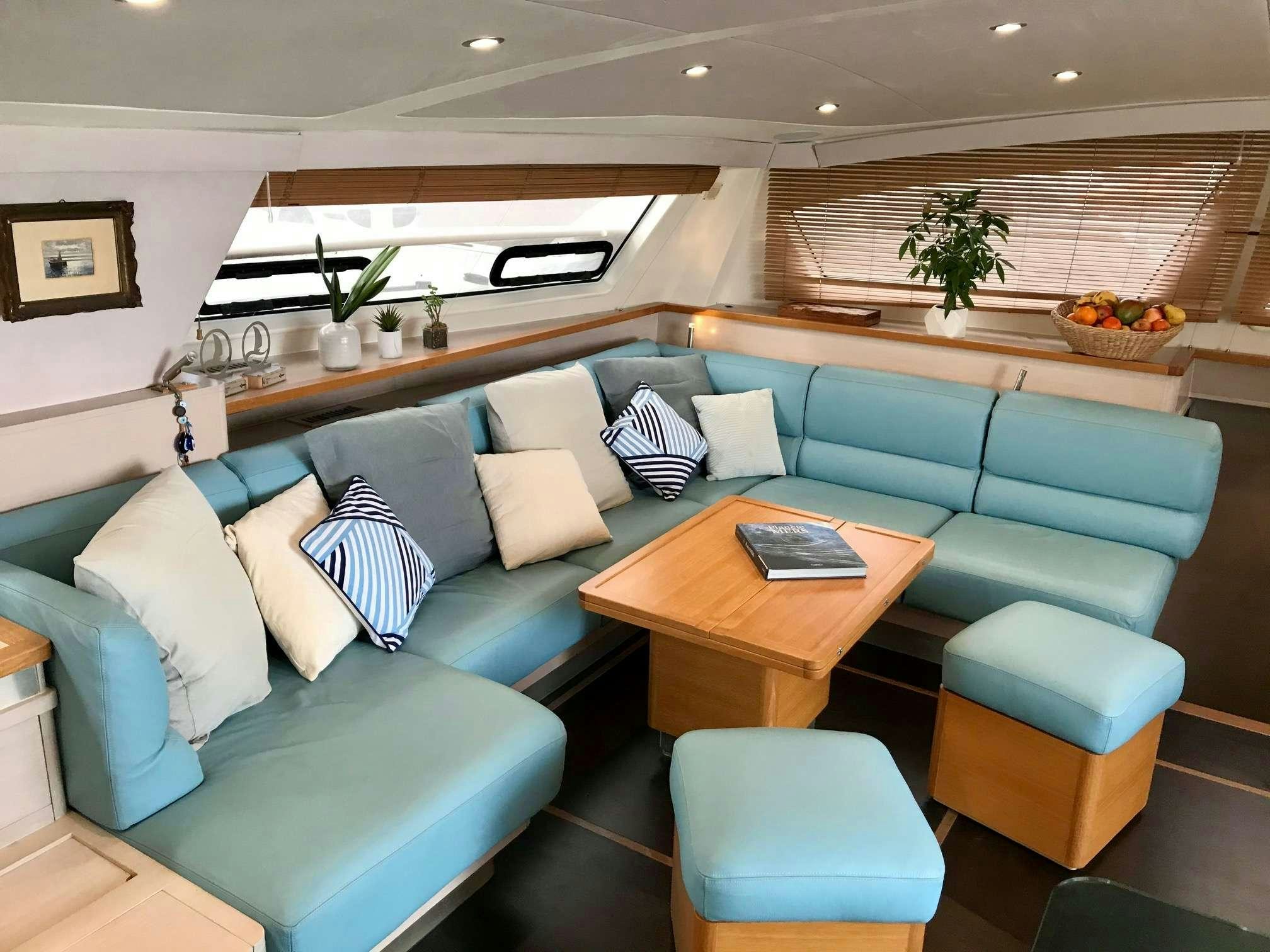 a living room with a couch and a table aboard STADIUM Yacht for Charter