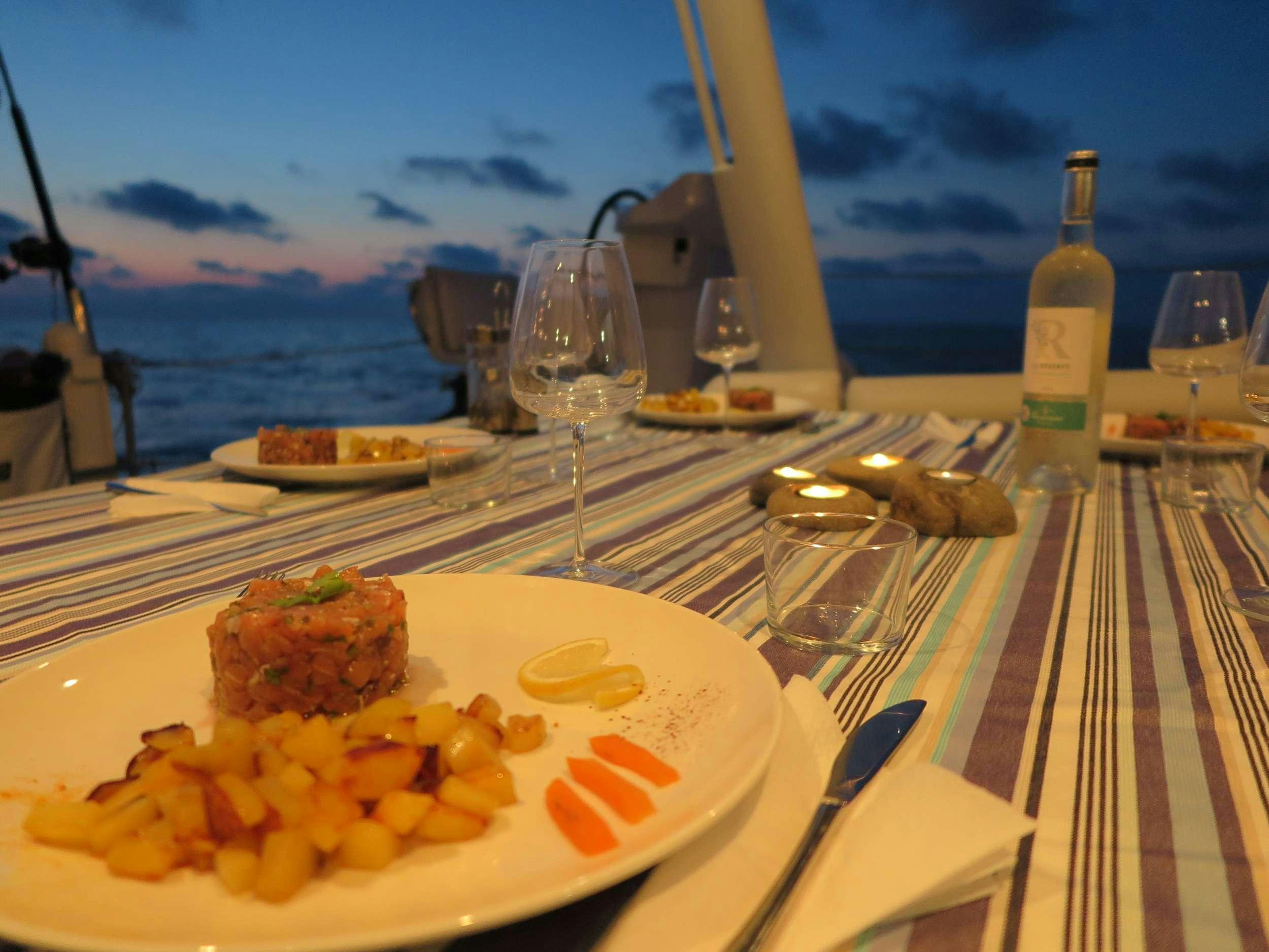 a table with food and drinks on it aboard STADIUM Yacht for Charter