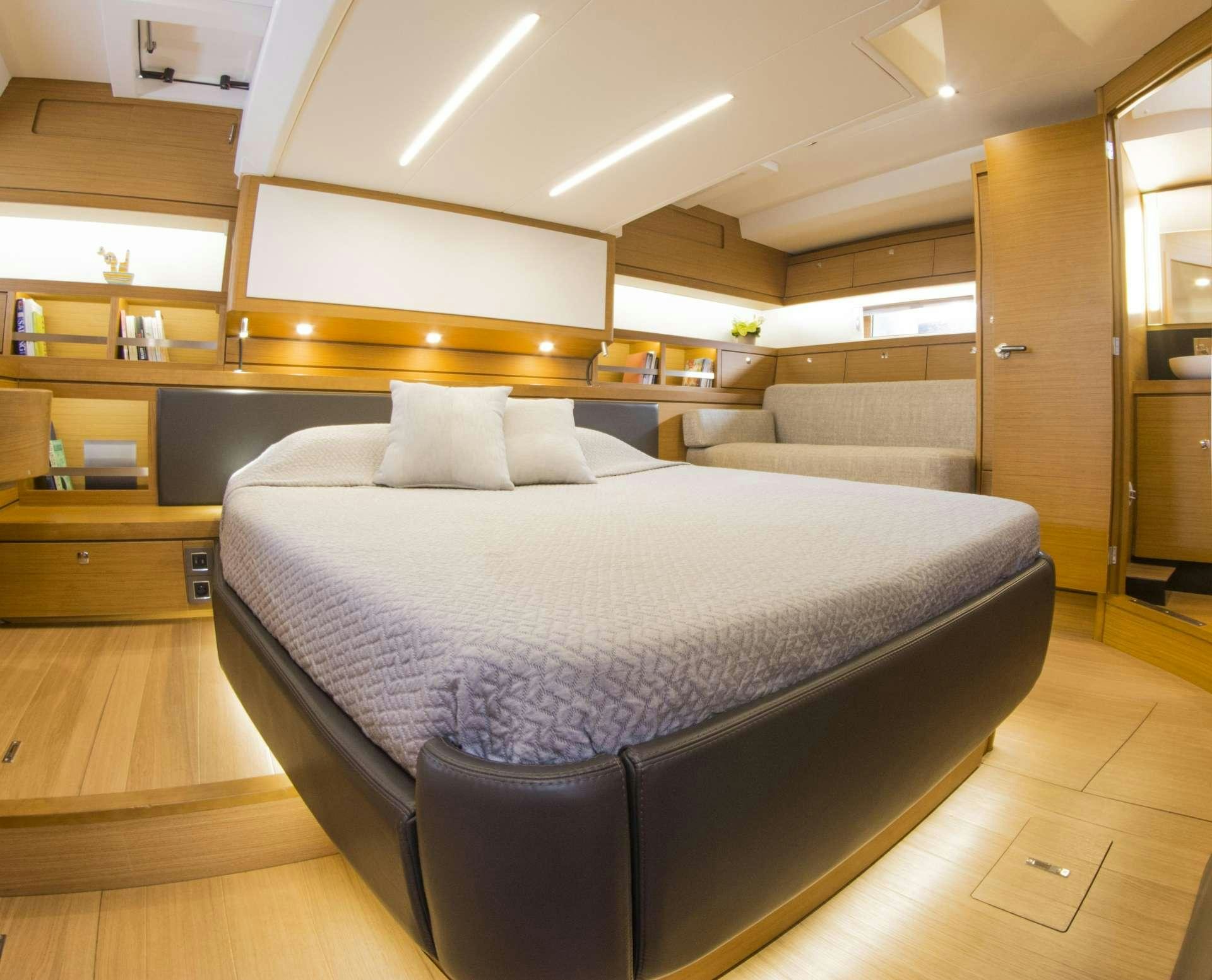 a large bed in a room aboard SOPHIA Yacht for Charter
