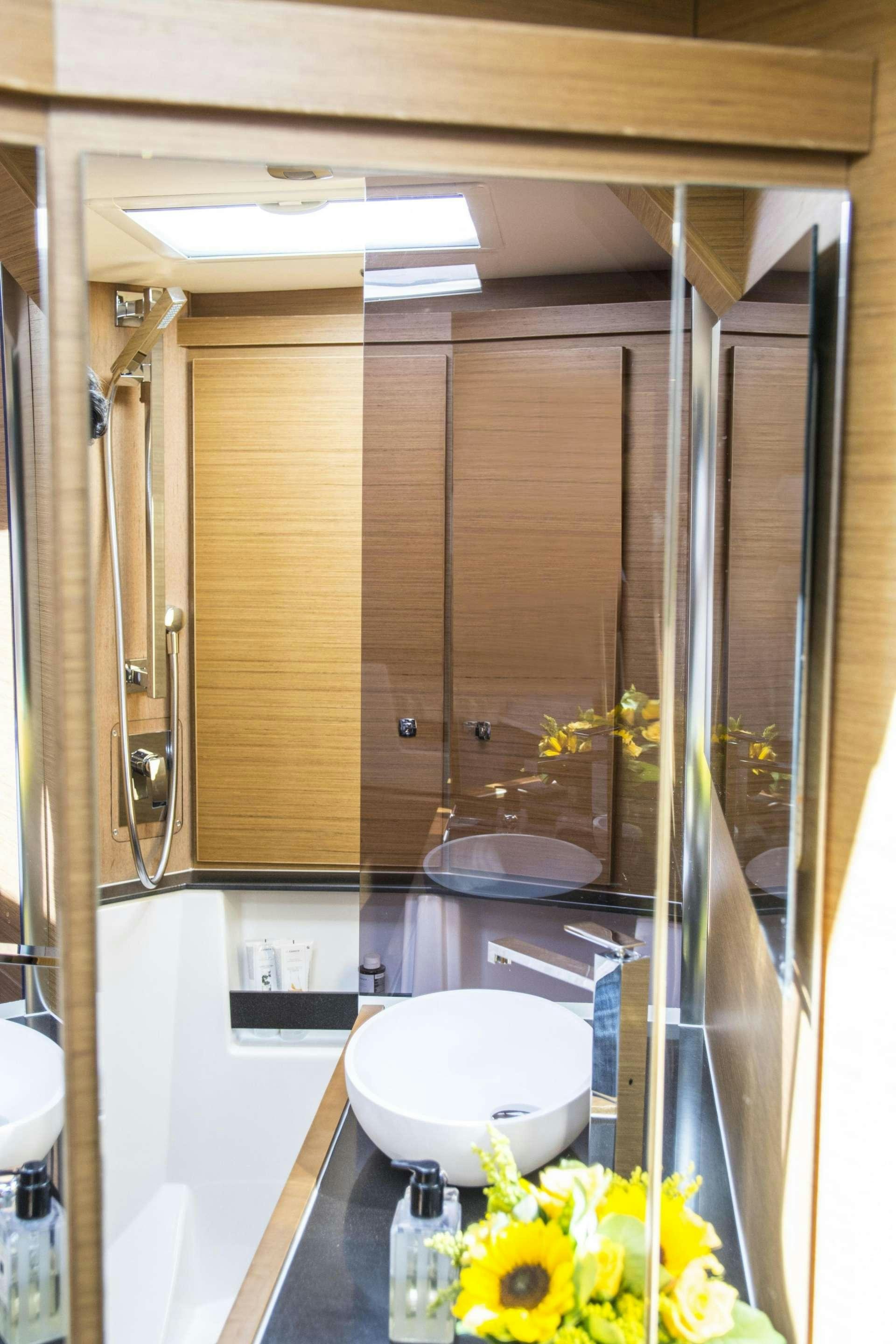 a bathroom with a glass shower aboard SOPHIA Yacht for Charter