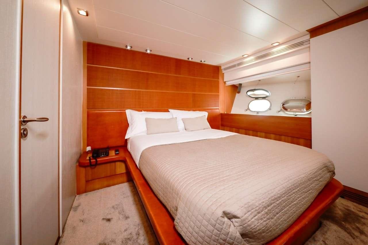 a room with a bed and a wood wall aboard SERENITY III Yacht for Charter