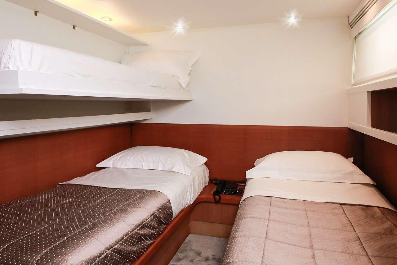 a couple of beds in a room aboard SERENITY III Yacht for Charter