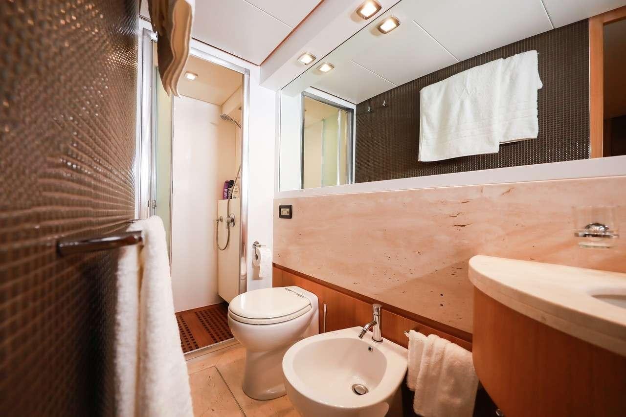 a bathroom with a sink toilet and a bathtub aboard SERENITY III Yacht for Charter