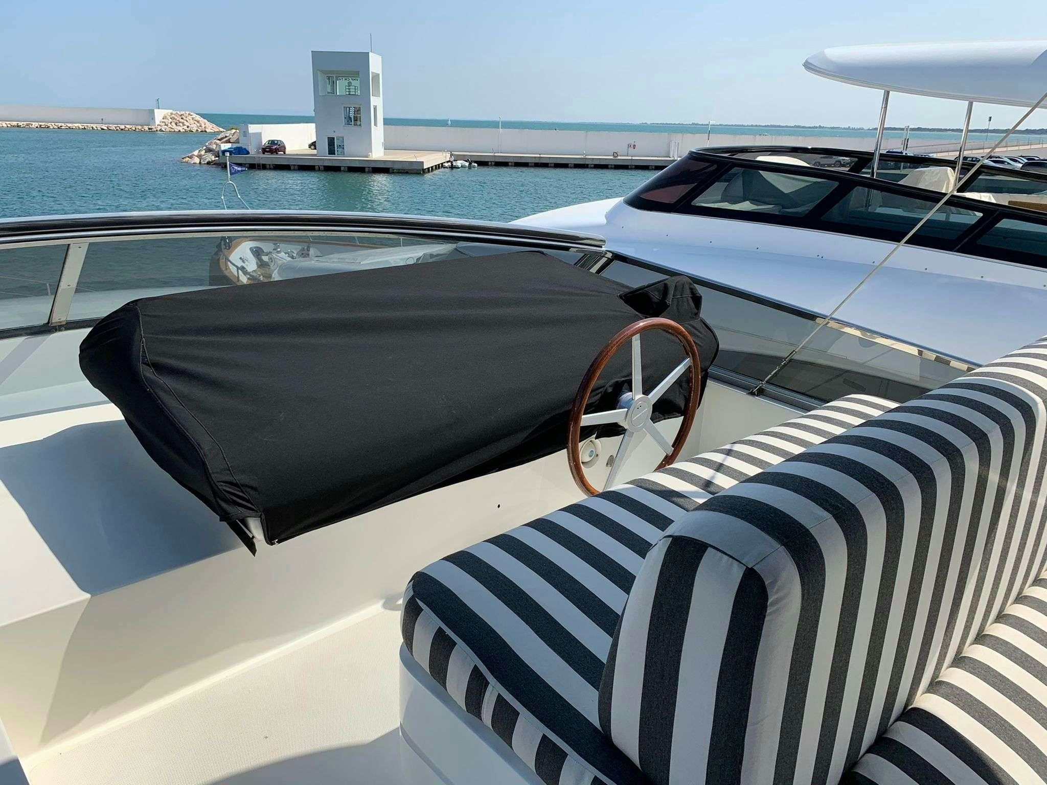 a boat with a white and black striped sail aboard SERENITY III Yacht for Charter