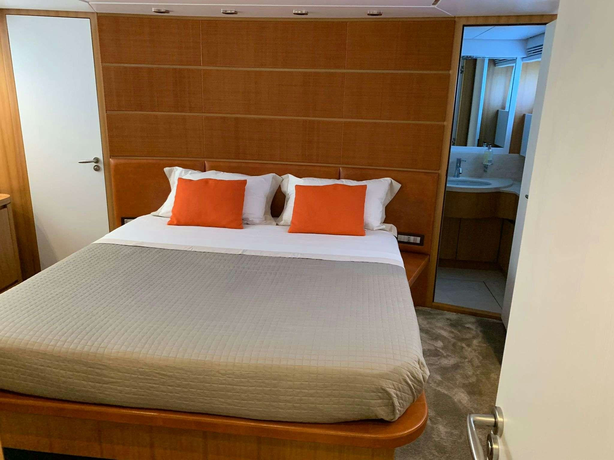 a bed with pillows on it aboard SERENITY III Yacht for Charter