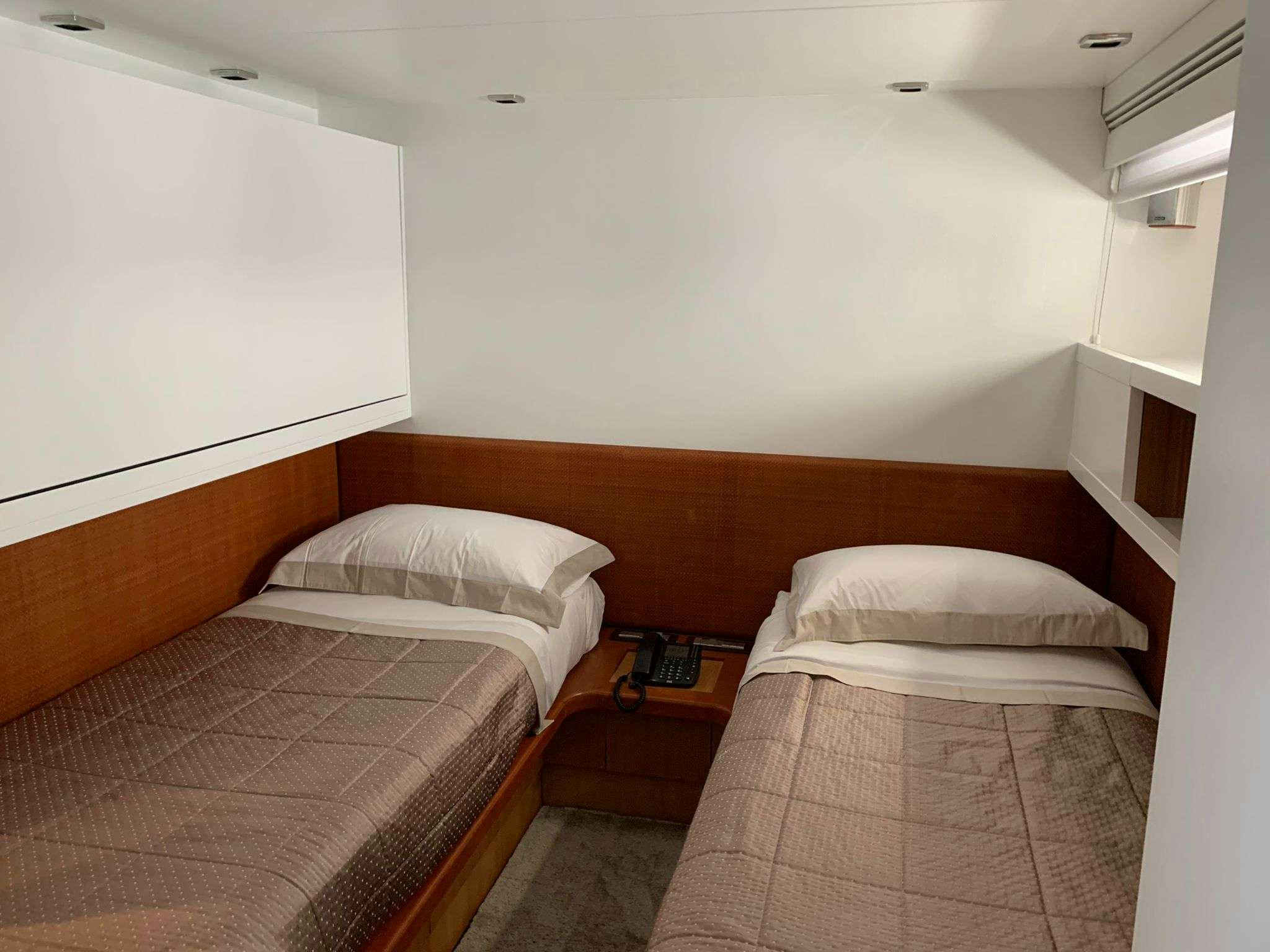 a couple of beds in a room aboard SERENITY III Yacht for Charter