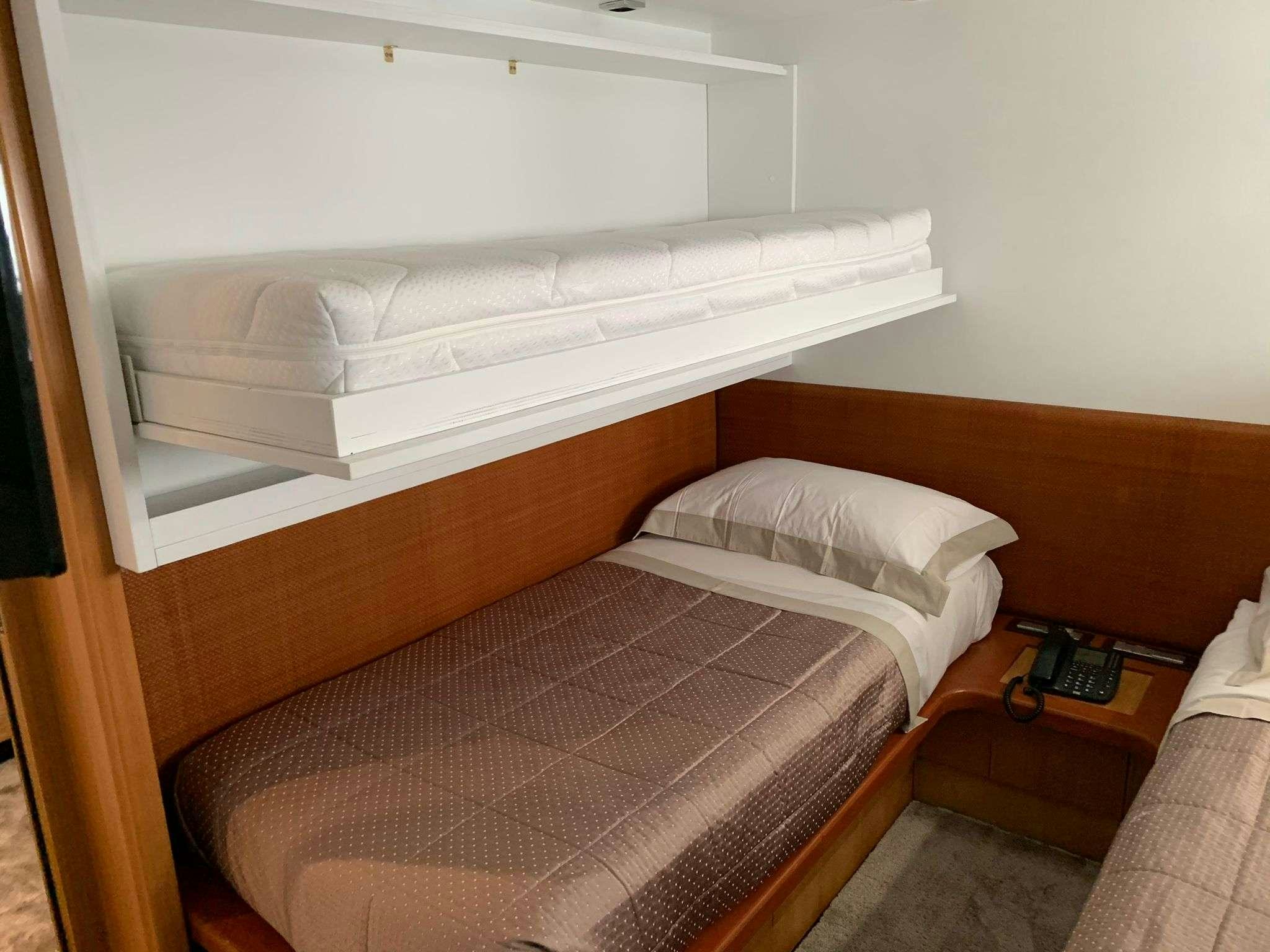 a bed with a pillow aboard SERENITY III Yacht for Charter