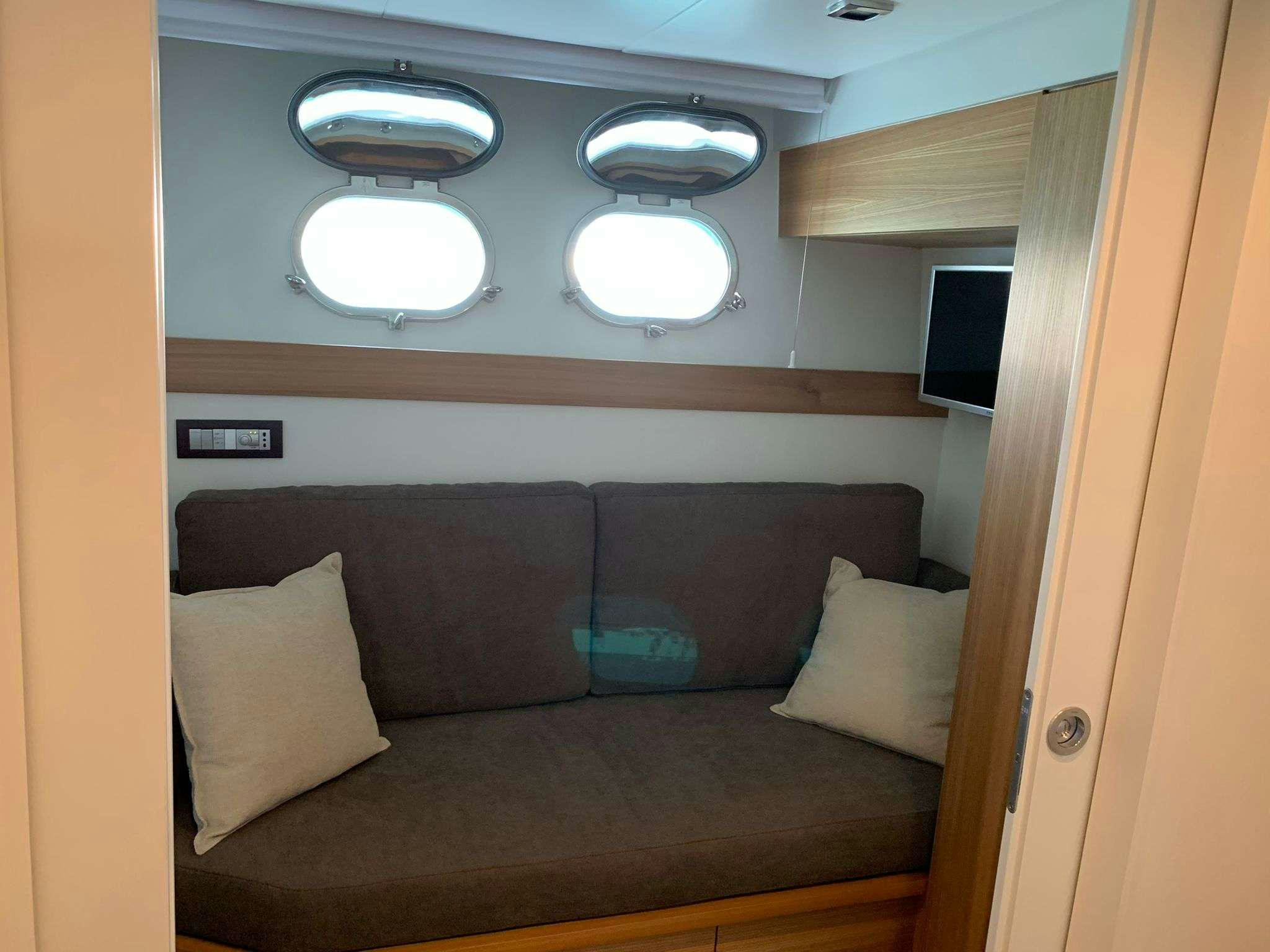 a couch in a room aboard SERENITY III Yacht for Charter