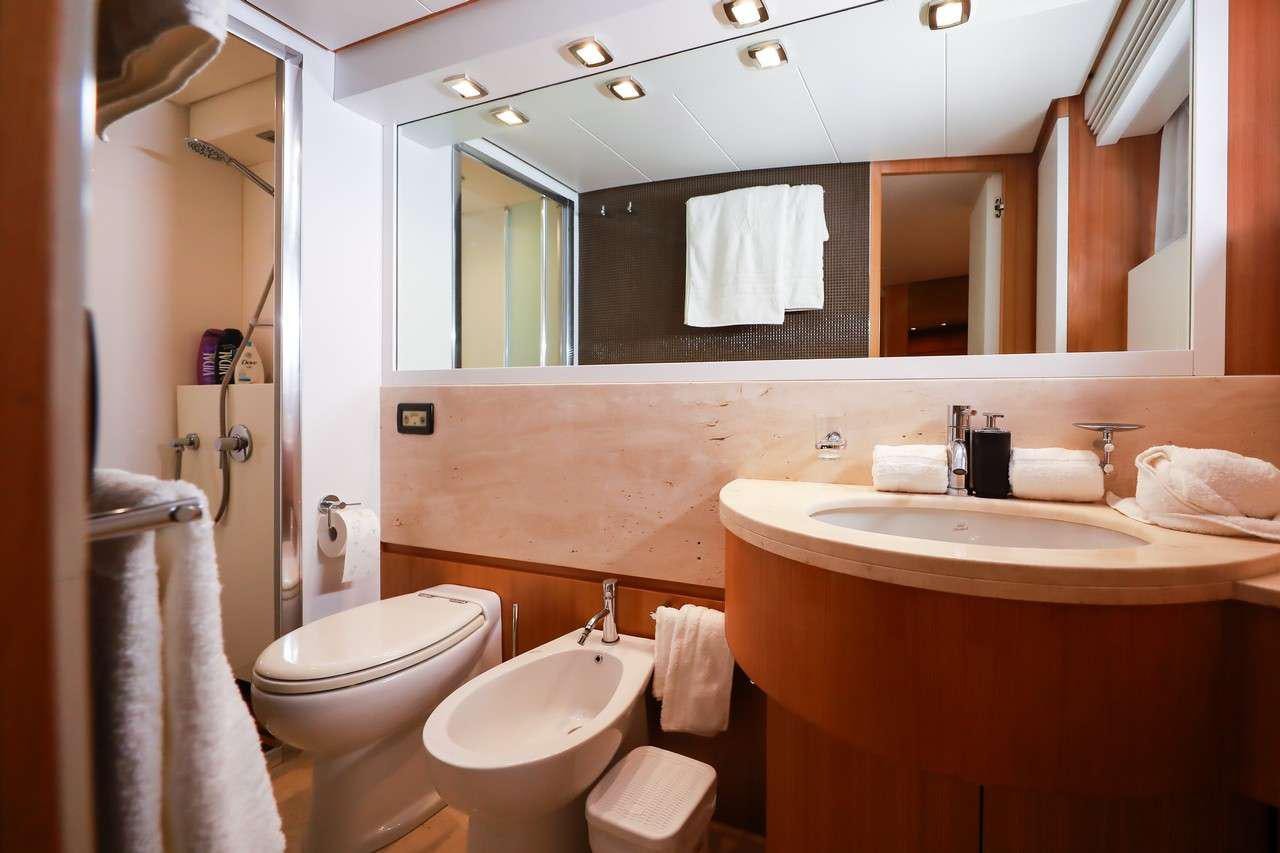 a bathroom with a large mirror aboard SERENITY III Yacht for Charter