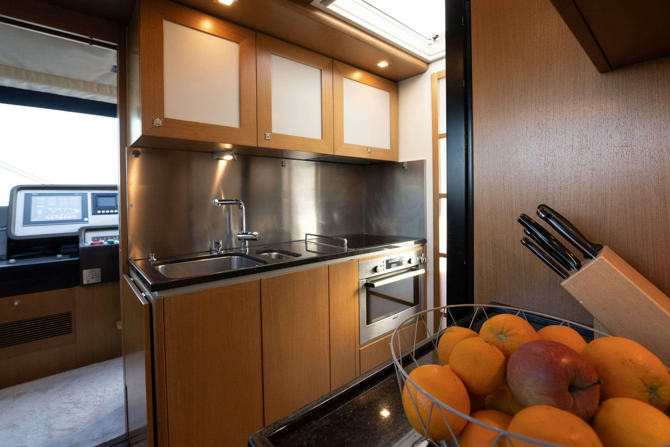 a kitchen with oranges aboard NINETEEN Yacht for Charter