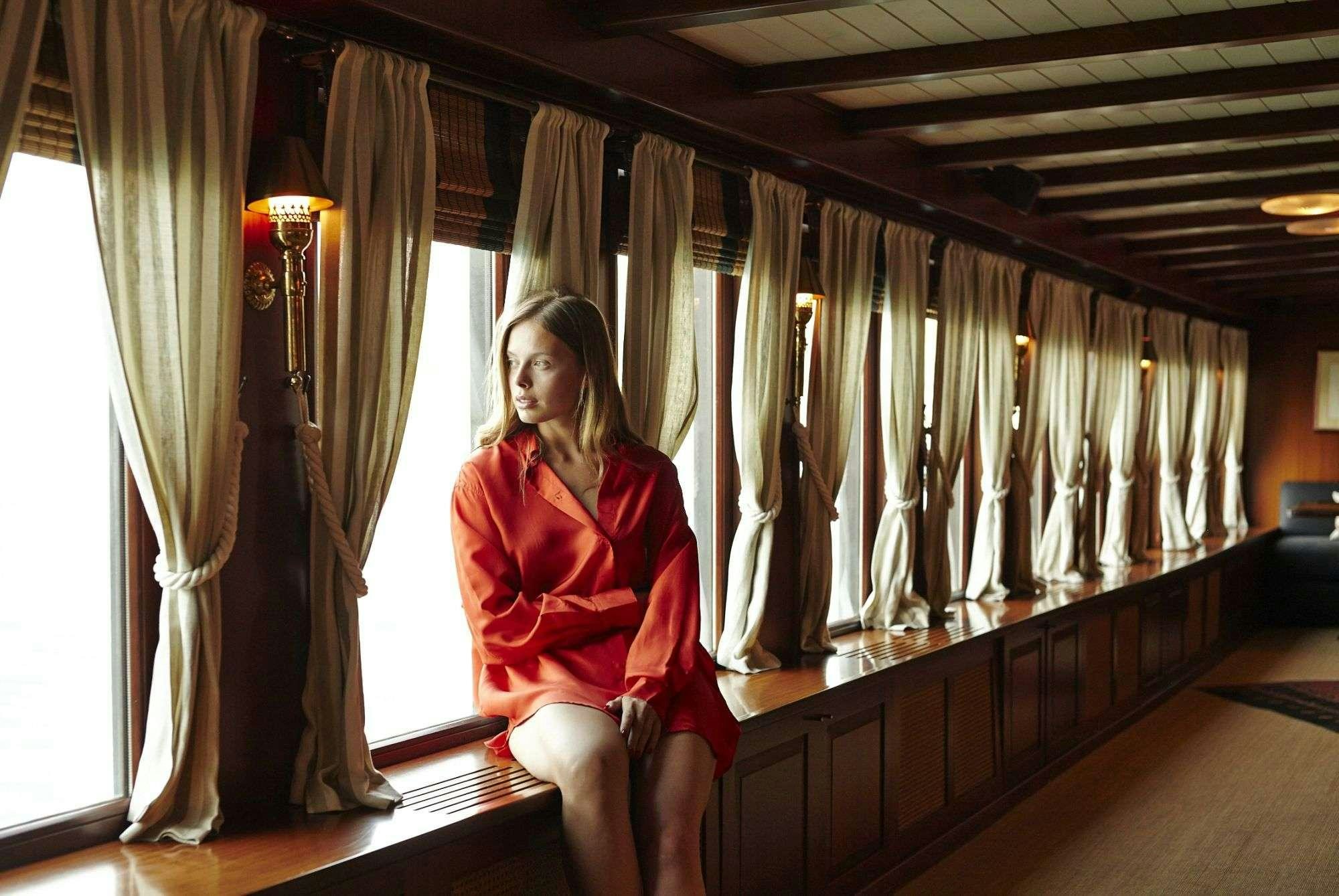 a person sitting on a bench aboard HALAS 71 Yacht for Charter