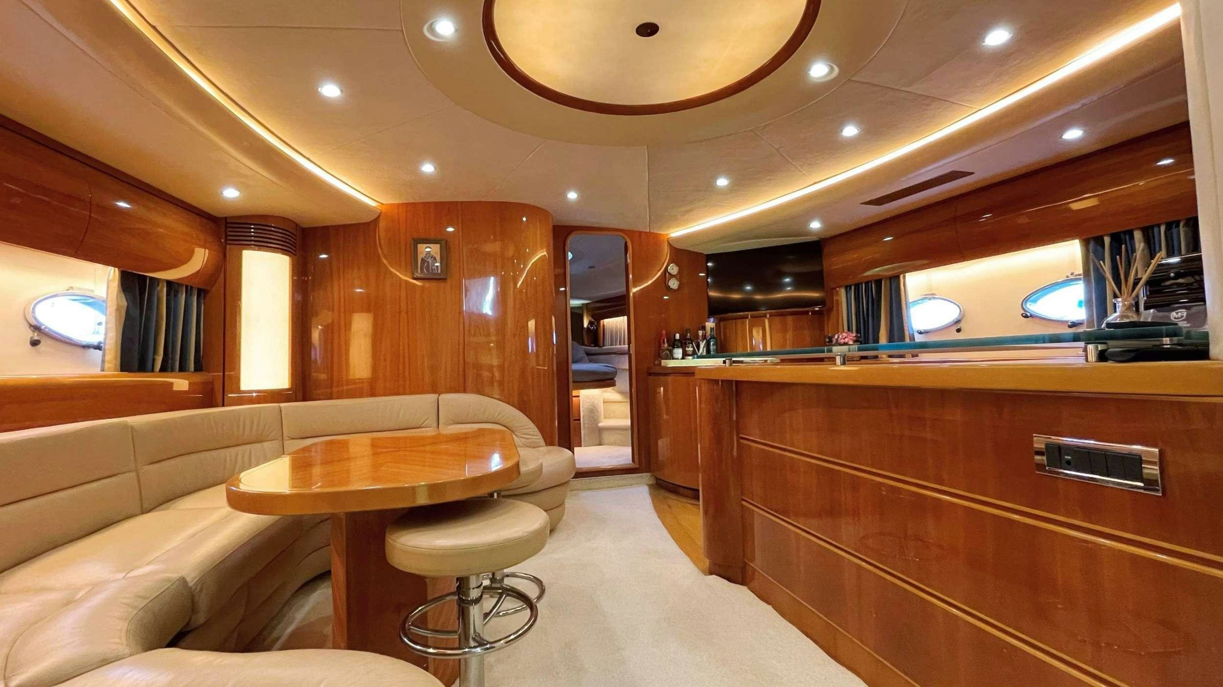 a room with a table and couch aboard VENUS Yacht for Charter