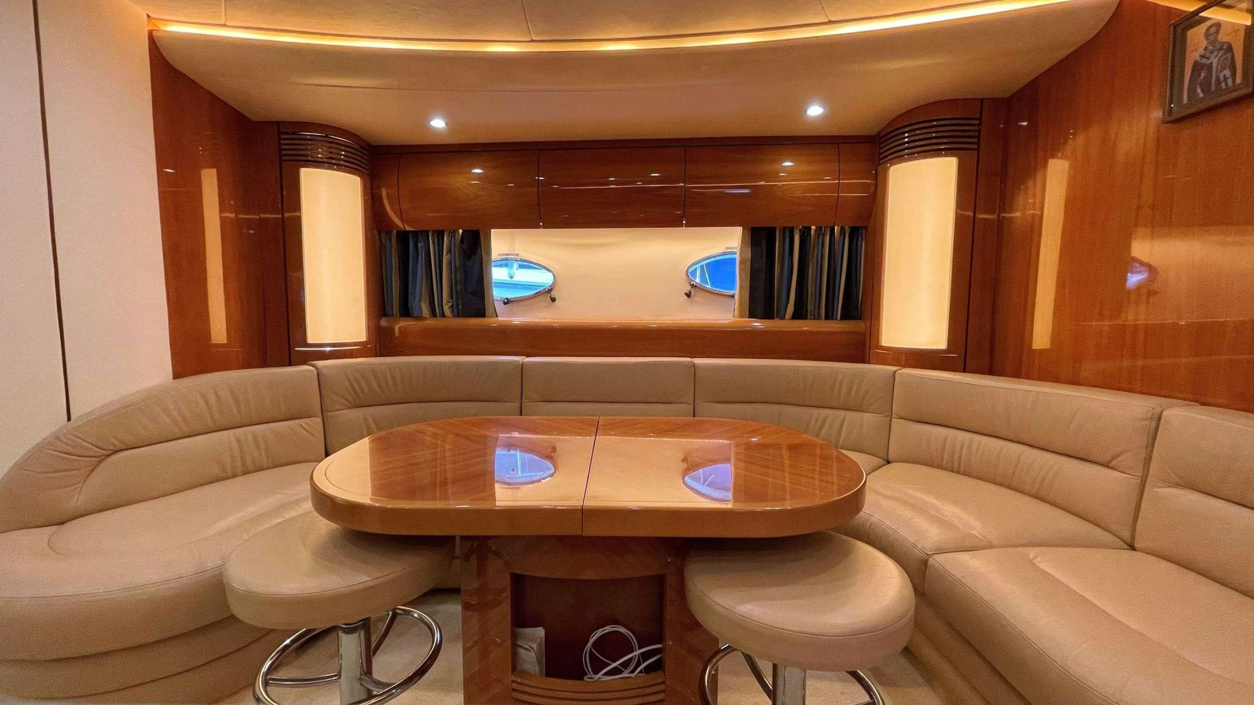 a room with a table and couch aboard VENUS Yacht for Charter