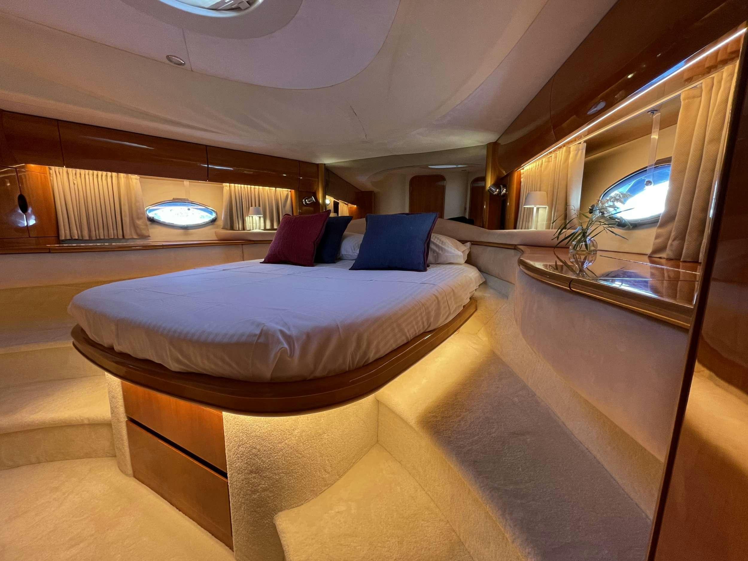 a room with a bed and a window aboard VENUS Yacht for Charter
