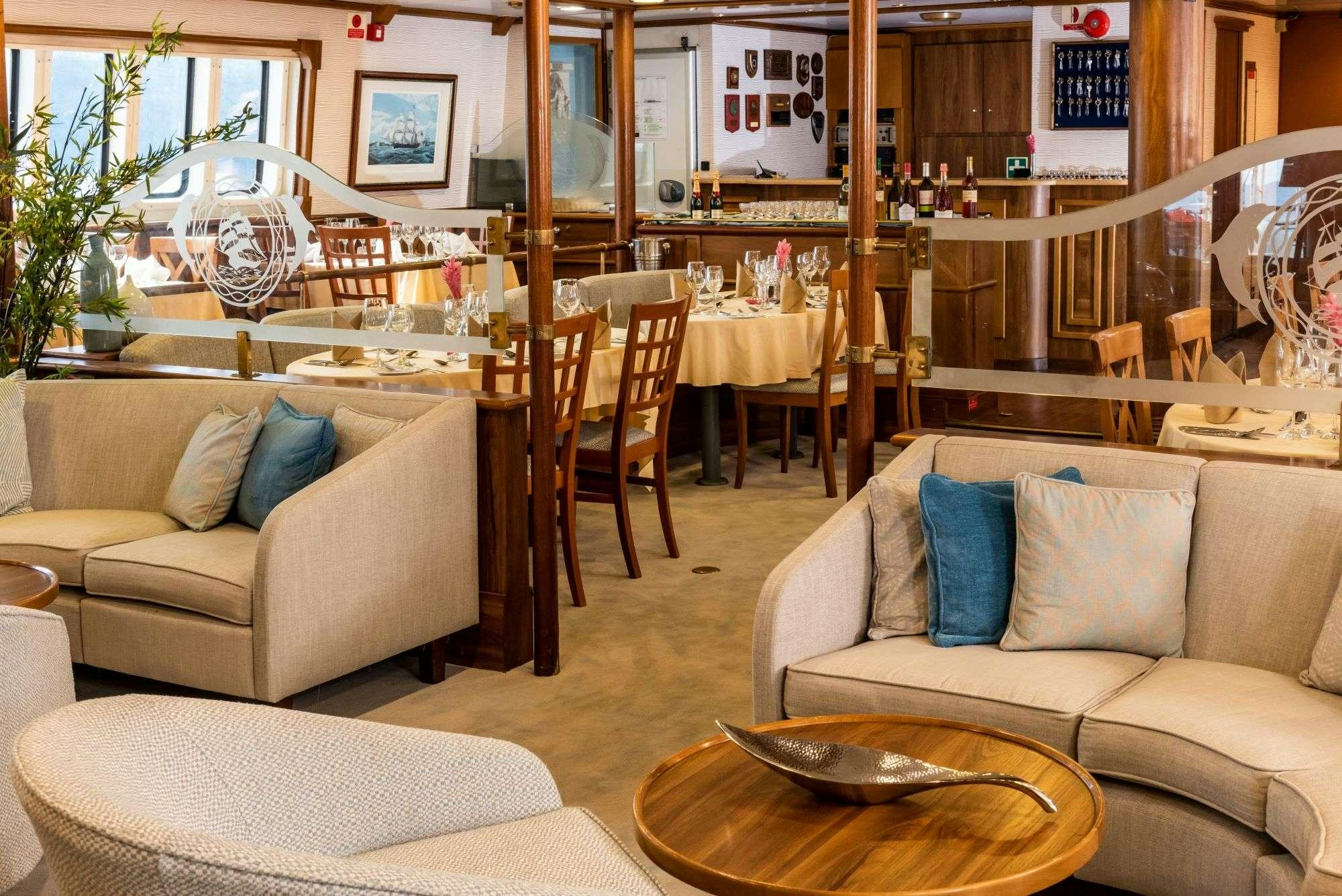 a living room with a couch and a coffee table aboard PAN ORAMA Yacht for Charter