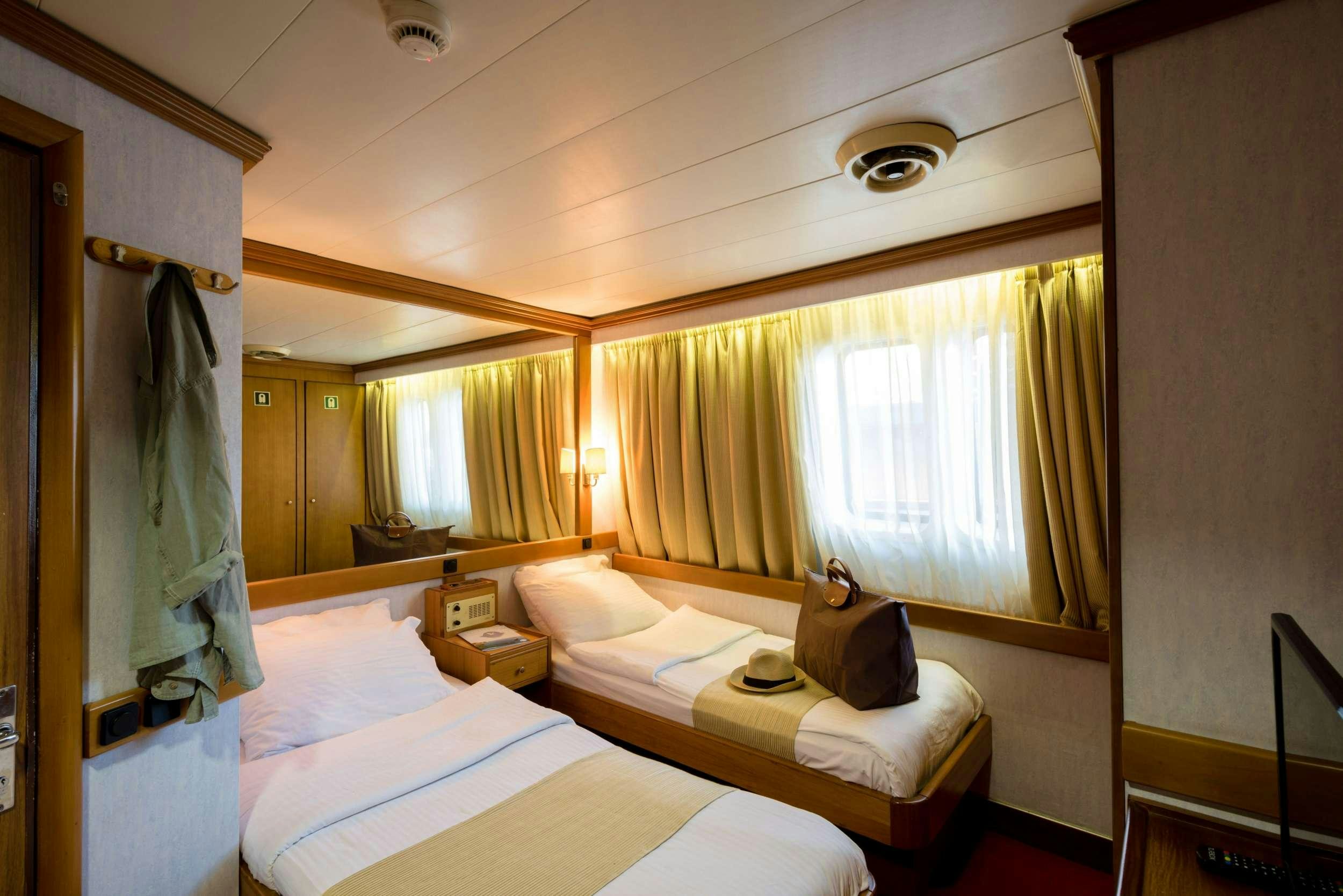 a couple of beds in a hotel room aboard PAN ORAMA Yacht for Charter