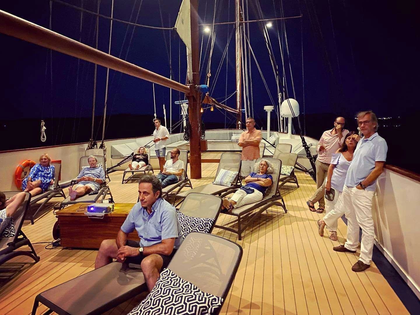 a group of people in a room aboard GALILEO Yacht for Charter