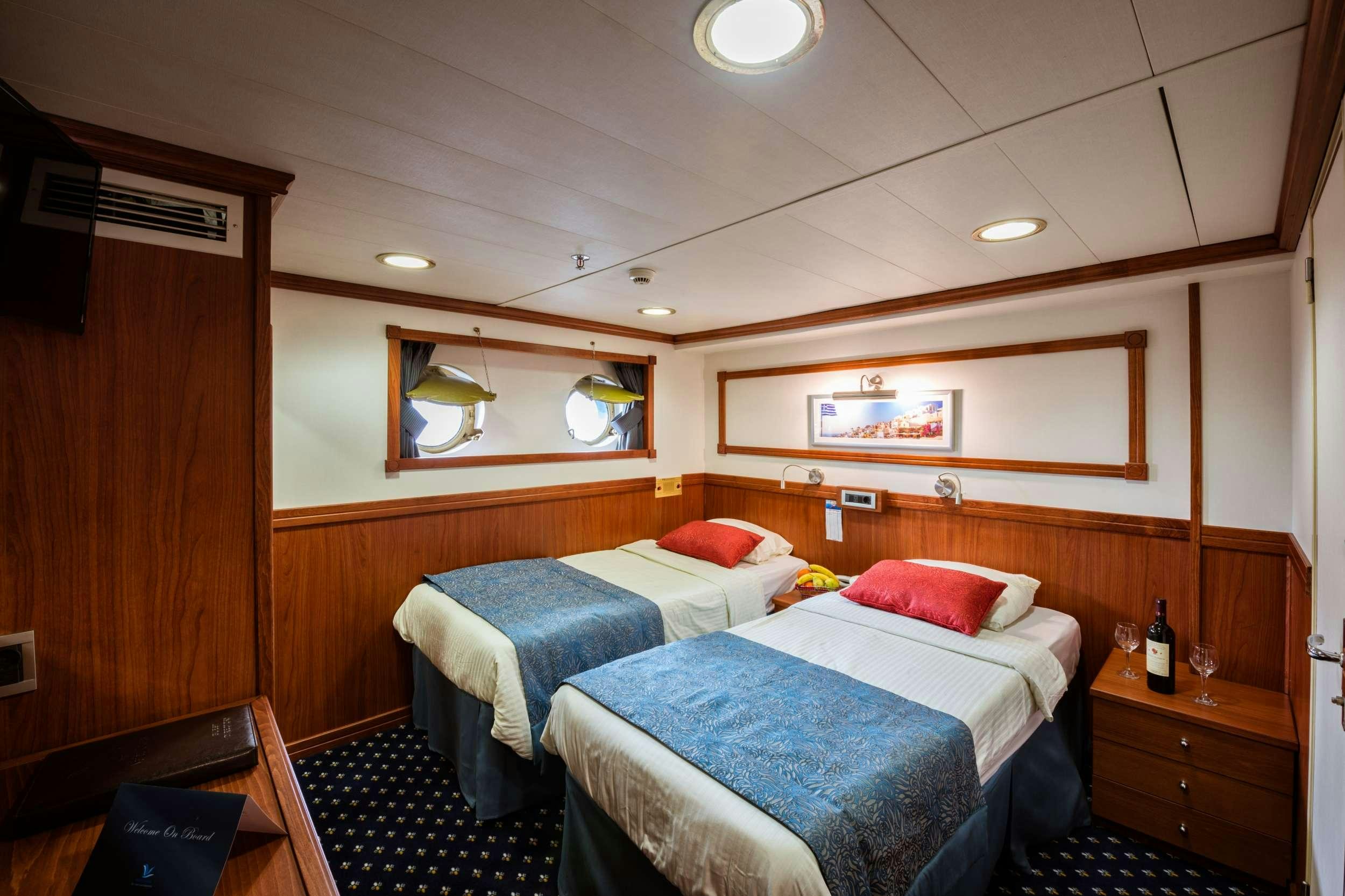 a room with two beds aboard GALILEO Yacht for Charter
