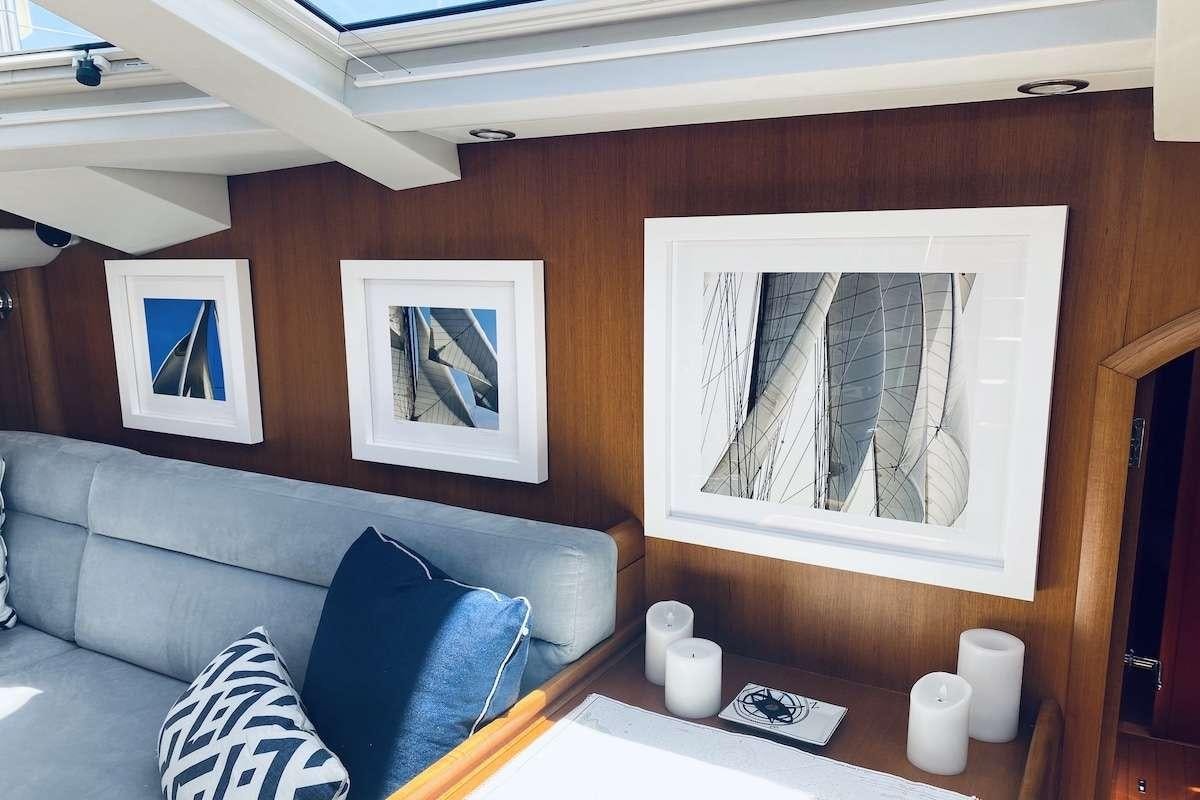 a living room with a large painting aboard AEGIS Yacht for Charter