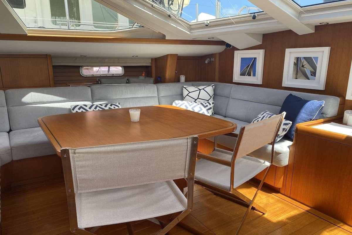a room with a table and chairs aboard AEGIS Yacht for Charter