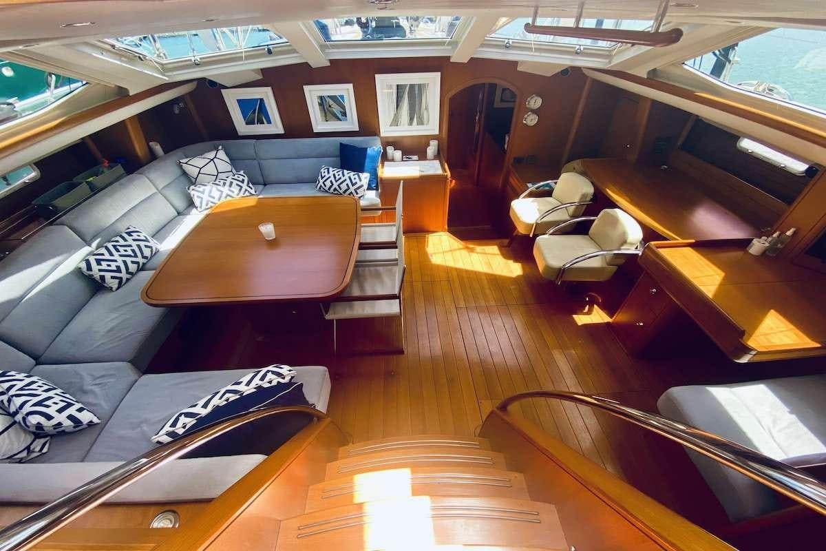 a room with a table and chairs aboard AEGIS Yacht for Charter